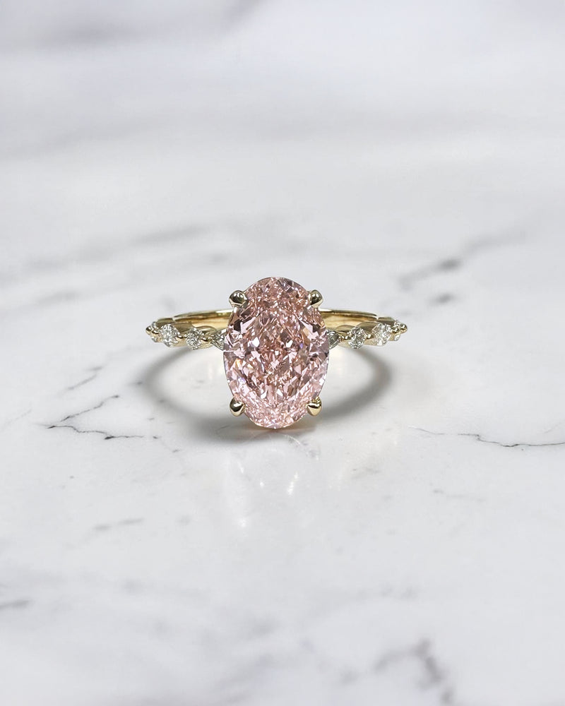 3ct pink oval cut lab grown diamond engagement ring with a floating setting, marquise and round diamond band in 18ct yellow gold, handcrafted in London by Layla Diamonds.