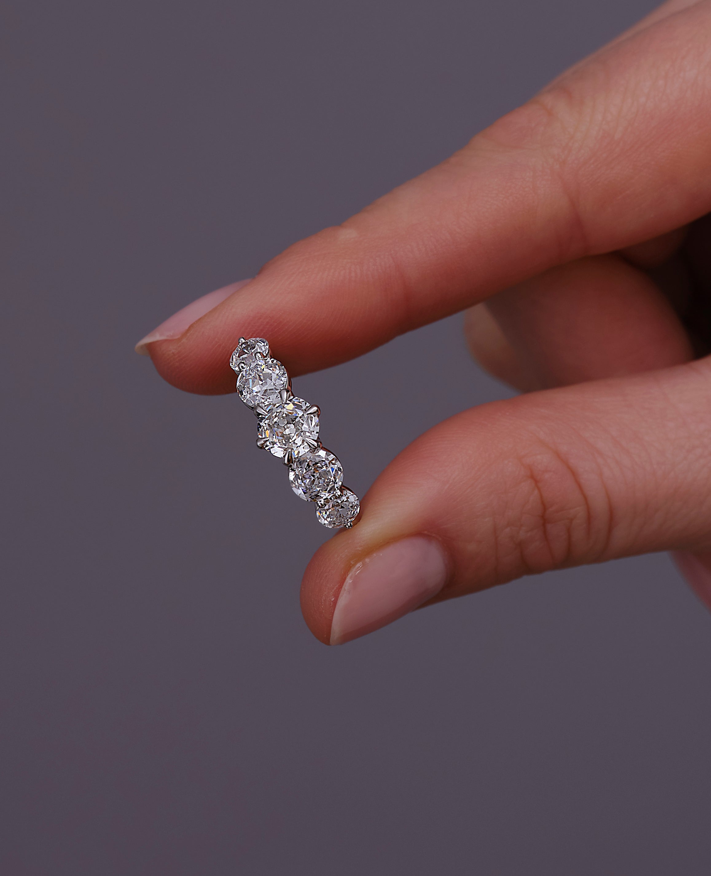 Close-up detail of the five graduated diamonds on this elegant diamond rings for women style.