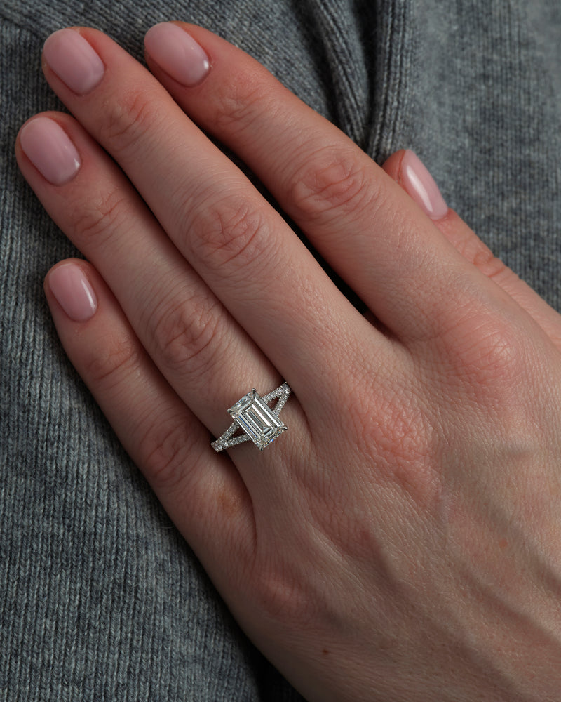 3ct Emerald Cut Split Shank lab grown diamond engagement ring on hand