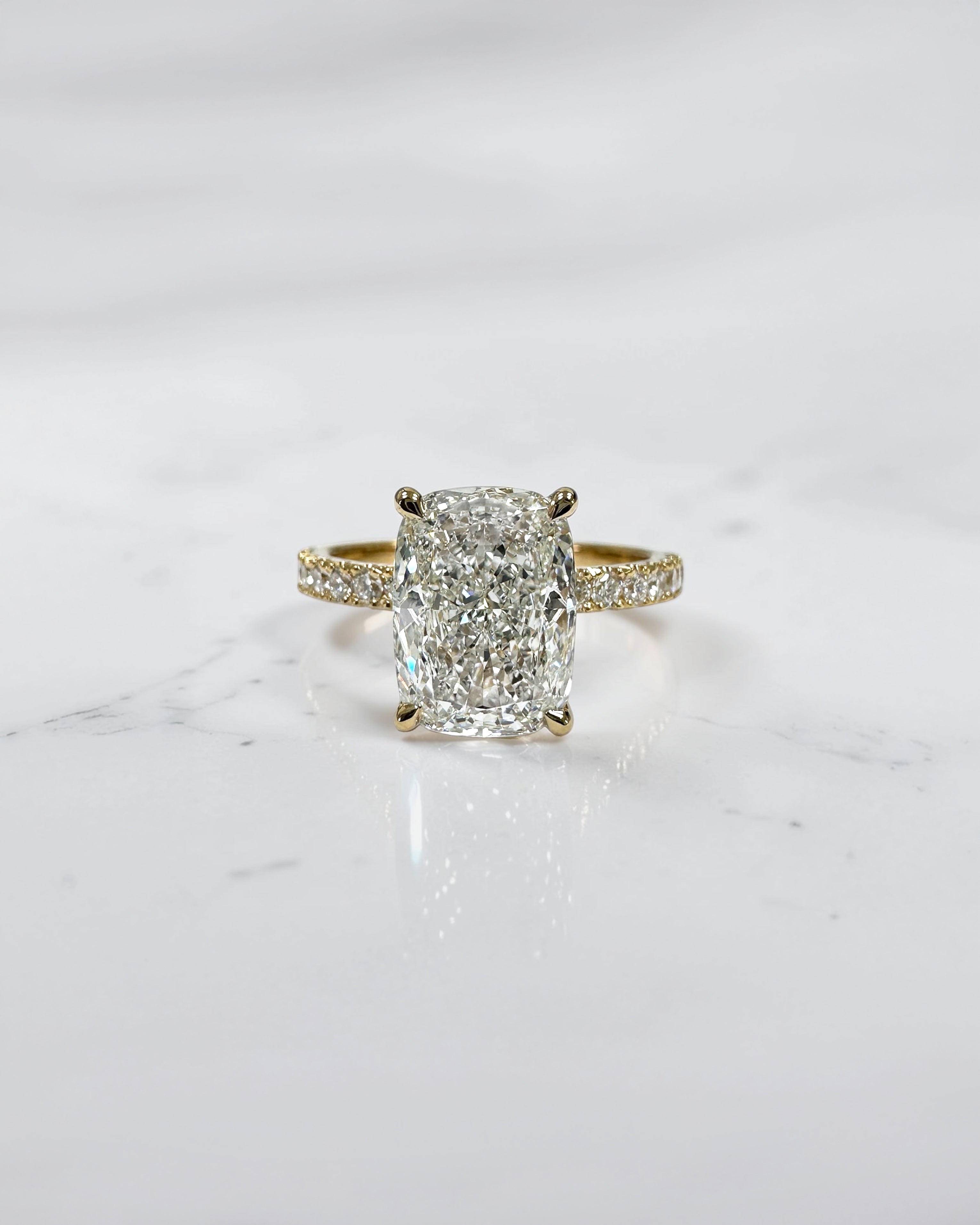 3ct elongated cushion cut lab grown diamond engagement ring with hidden halo diamond shoulders and floating setting in yellow gold handcrafted in London UK