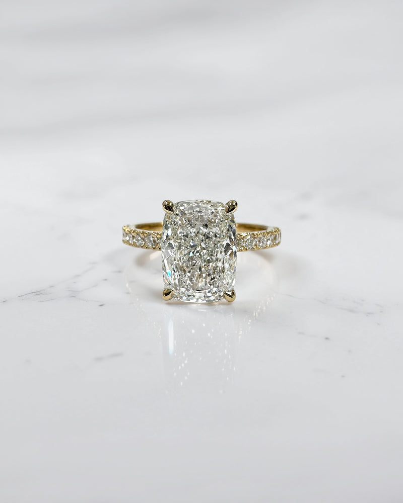 3ct elongated cushion cut lab grown diamond engagement ring with hidden halo diamond shoulders and floating setting in yellow gold handcrafted in London UK