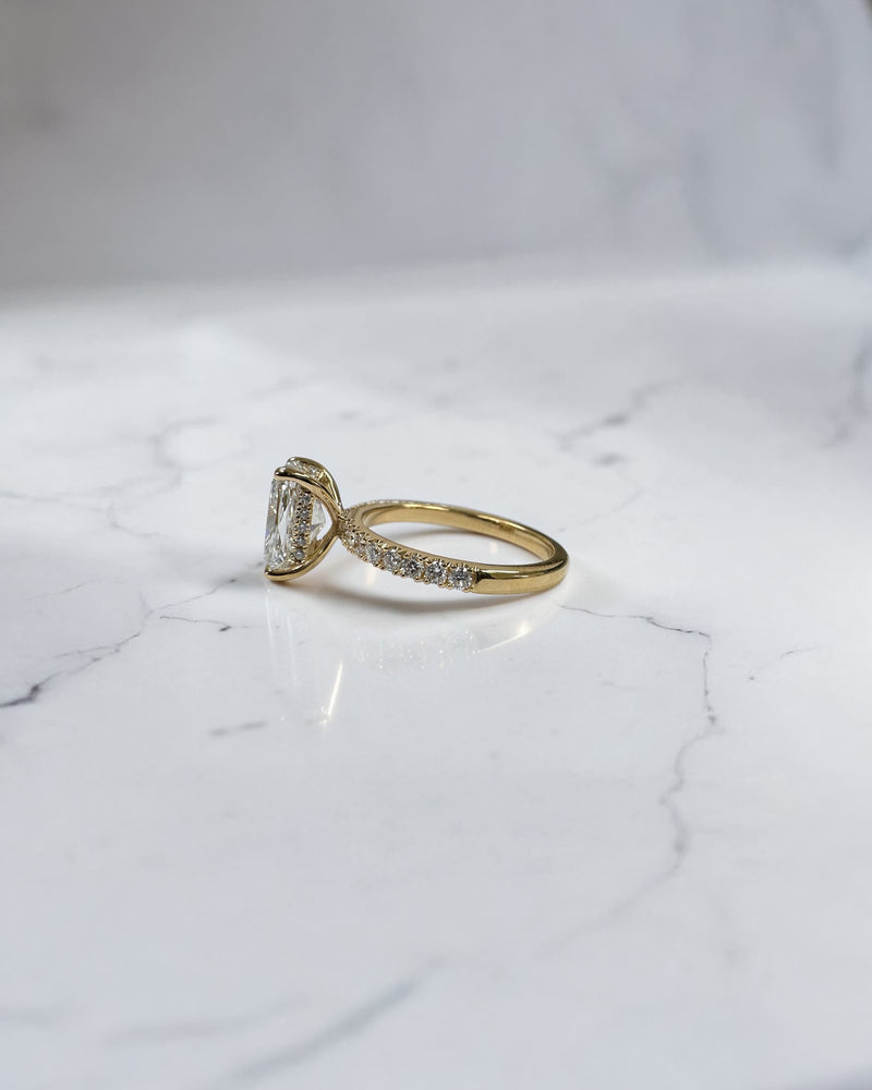 3ct elongated cushion cut diamond ring detail showing hidden halo and diamond bridge in yellow gold handcrafted in London UK