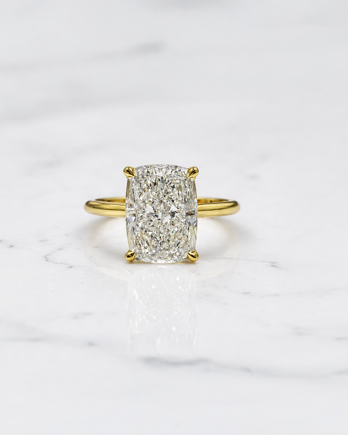 3ct elongated cushion cut lab grown diamond engagement ring with hidden halo and diamond bridge in yellow gold handcrafted in London UK by Layla Diamonds
