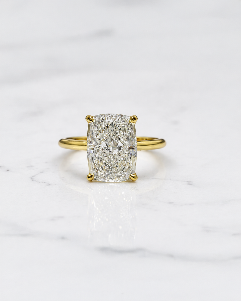 3ct elongated cushion cut lab grown diamond engagement ring with hidden halo and diamond bridge in yellow gold handcrafted in London UK by Layla Diamonds