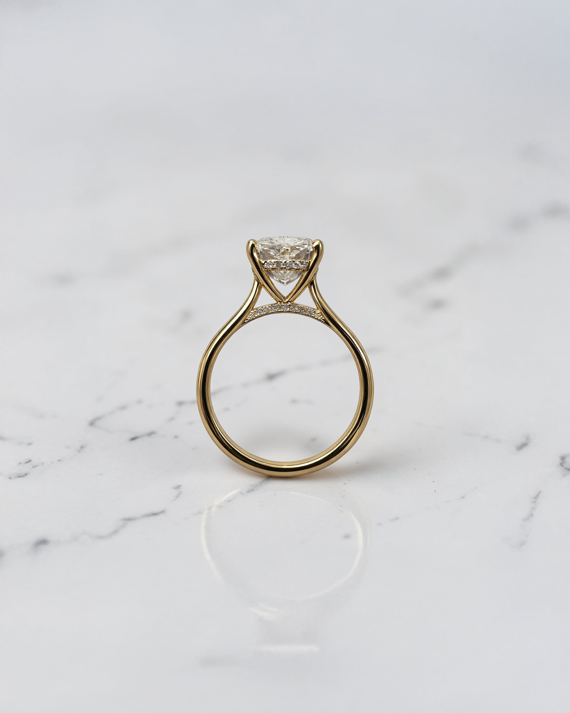3ct elongated cushion cut lab grown diamond engagement ring with hidden halo and diamond bridge in yellow gold handcrafted in London UK by Layla Diamonds