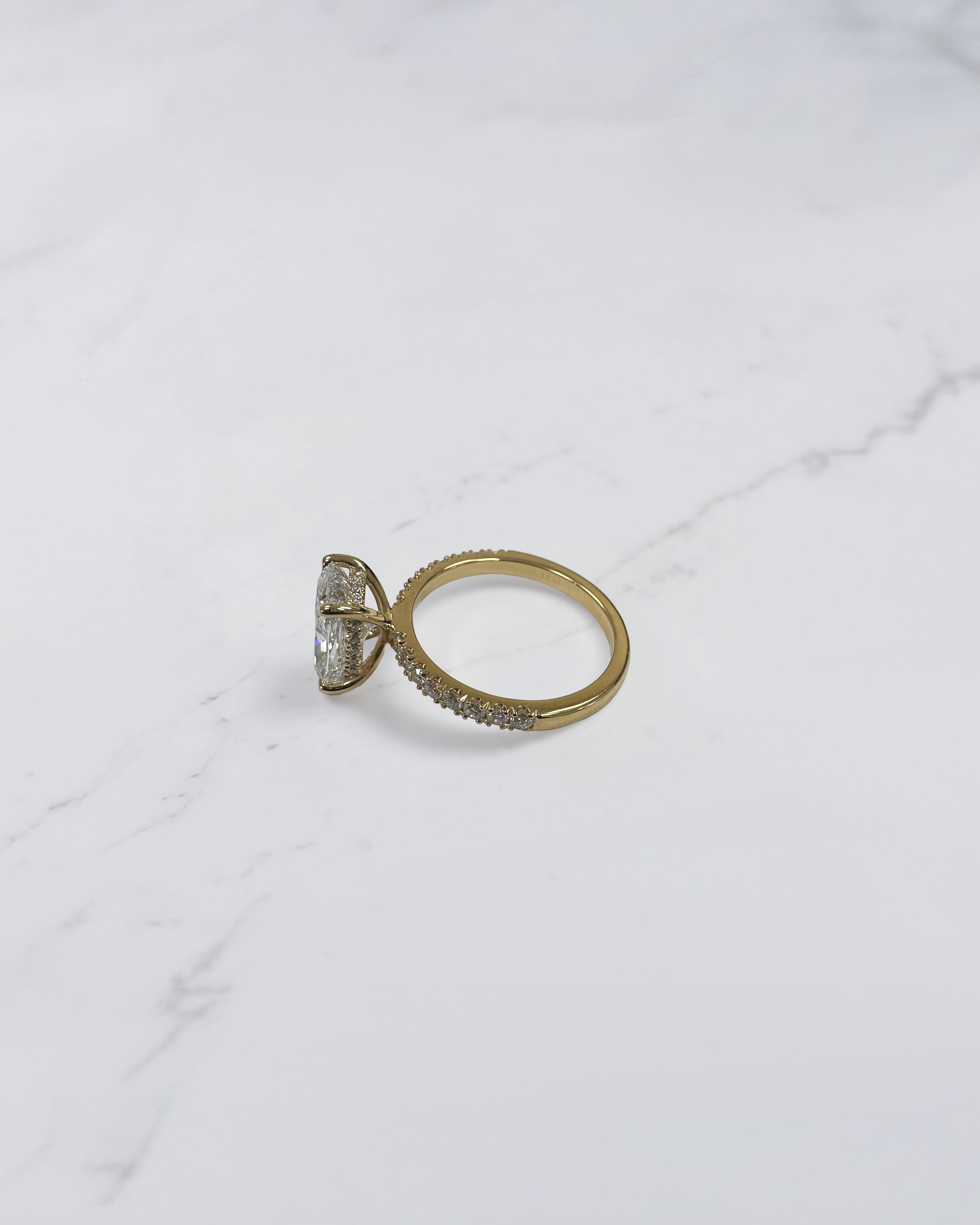 3ct elongated cushion cut diamond ring detail showing hidden halo and diamond bridge in yellow gold handcrafted in London UK