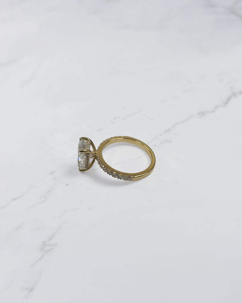 3ct elongated cushion cut diamond ring detail showing hidden halo and diamond bridge in yellow gold handcrafted in London UK