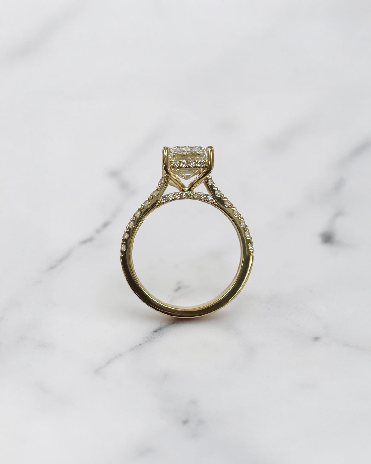 3ct emerald cut lab grown diamond cathedral engagement ring with diamond shoulders, hidden halo and diamond bridge