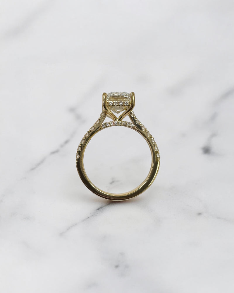 3ct emerald cut lab grown diamond cathedral engagement ring with diamond shoulders, hidden halo and diamond bridge