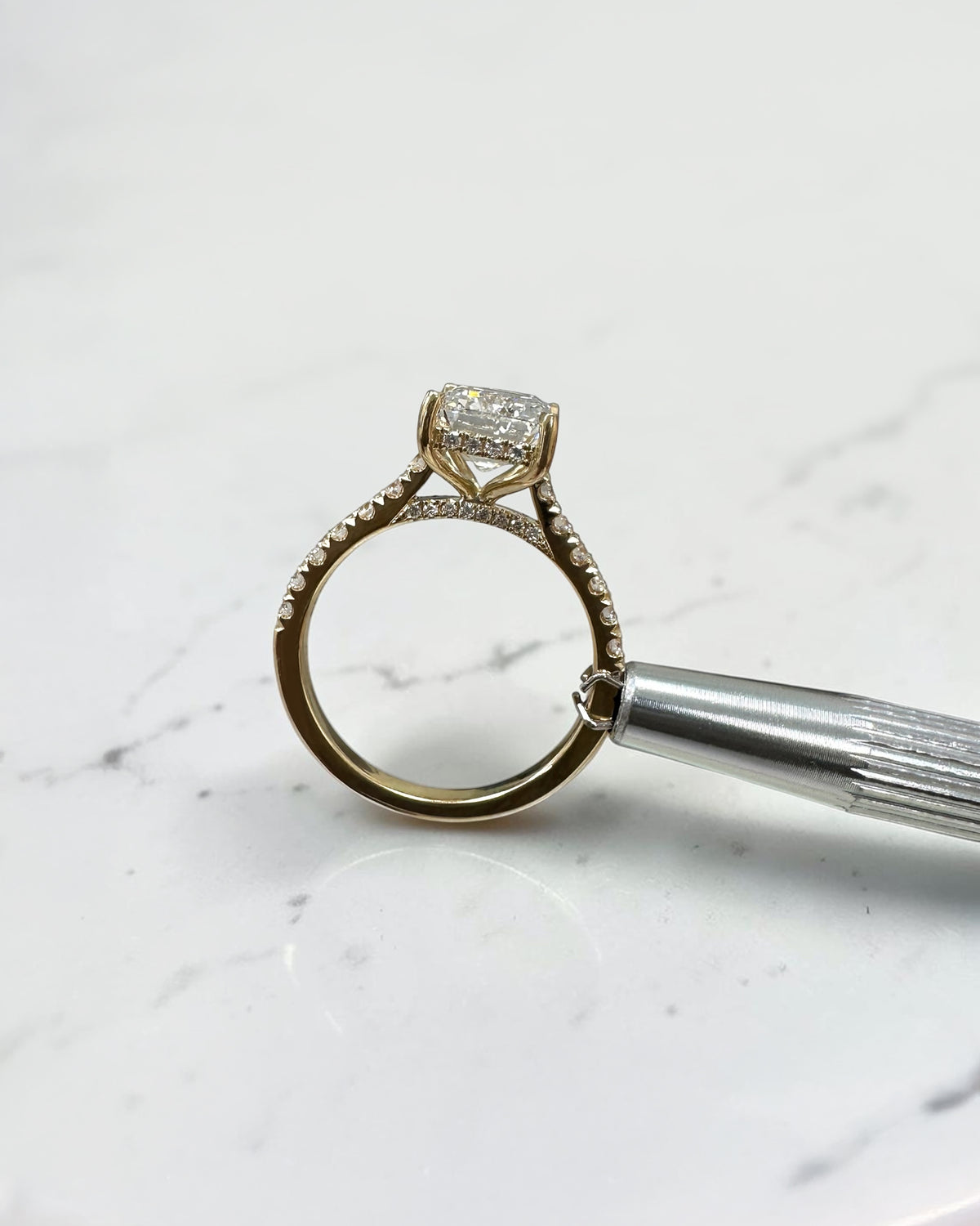 3ct emerald cut lab grown diamond cathedral engagement ring with diamond shoulders, hidden halo and diamond bridge