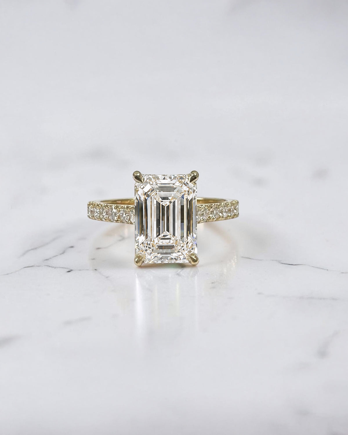 3ct emerald cut lab grown diamond cathedral engagement ring with diamond shoulders, hidden halo and diamond bridge