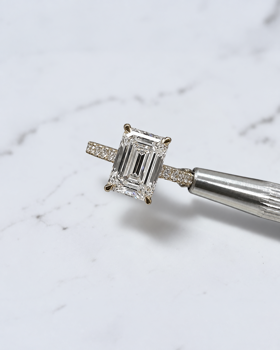 3ct emerald cut lab grown diamond cathedral engagement ring with diamond shoulders, hidden halo and diamond bridge