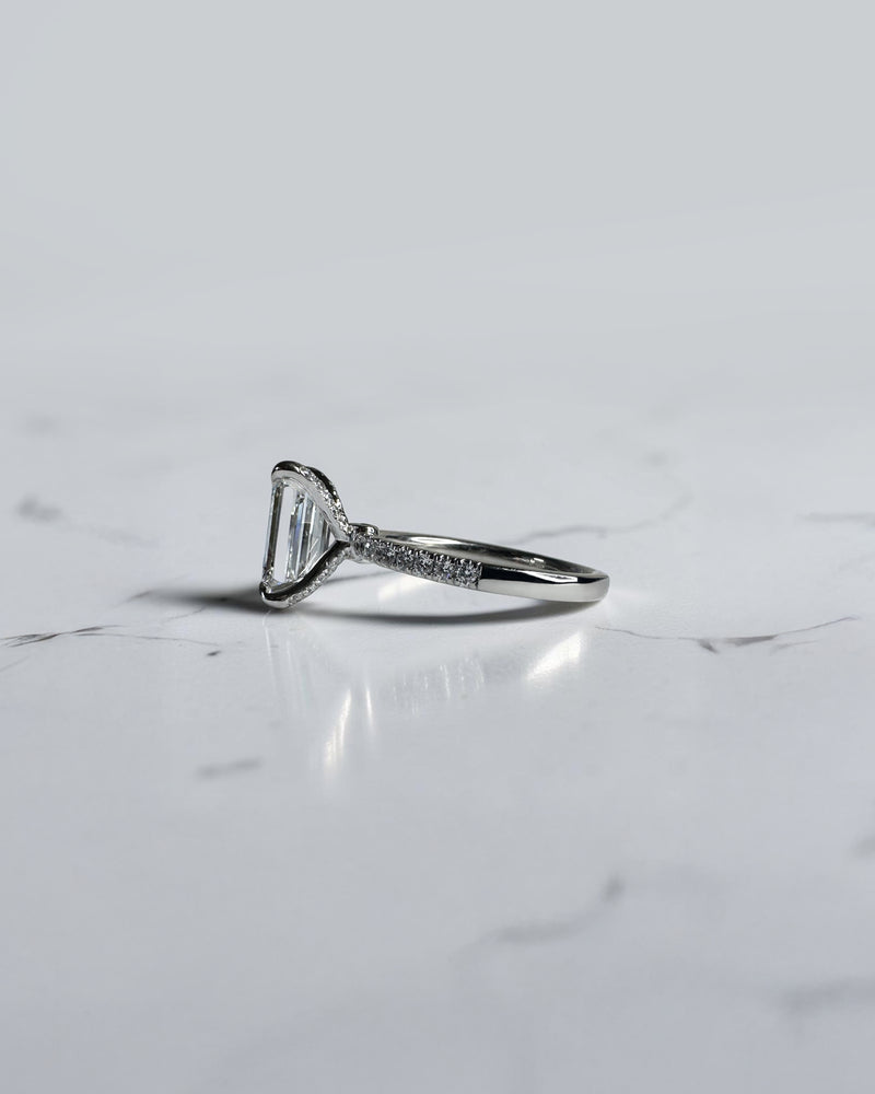 3ct emerald cut diamond ring with open diamond prongs setting and diamond shoulders, handcrafted in London