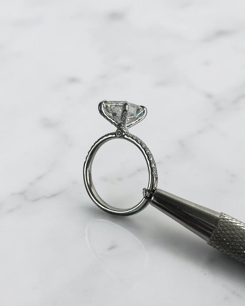 3ct emerald cut diamond ring with open diamond prong setting and diamond shoulders, handcrafted in London