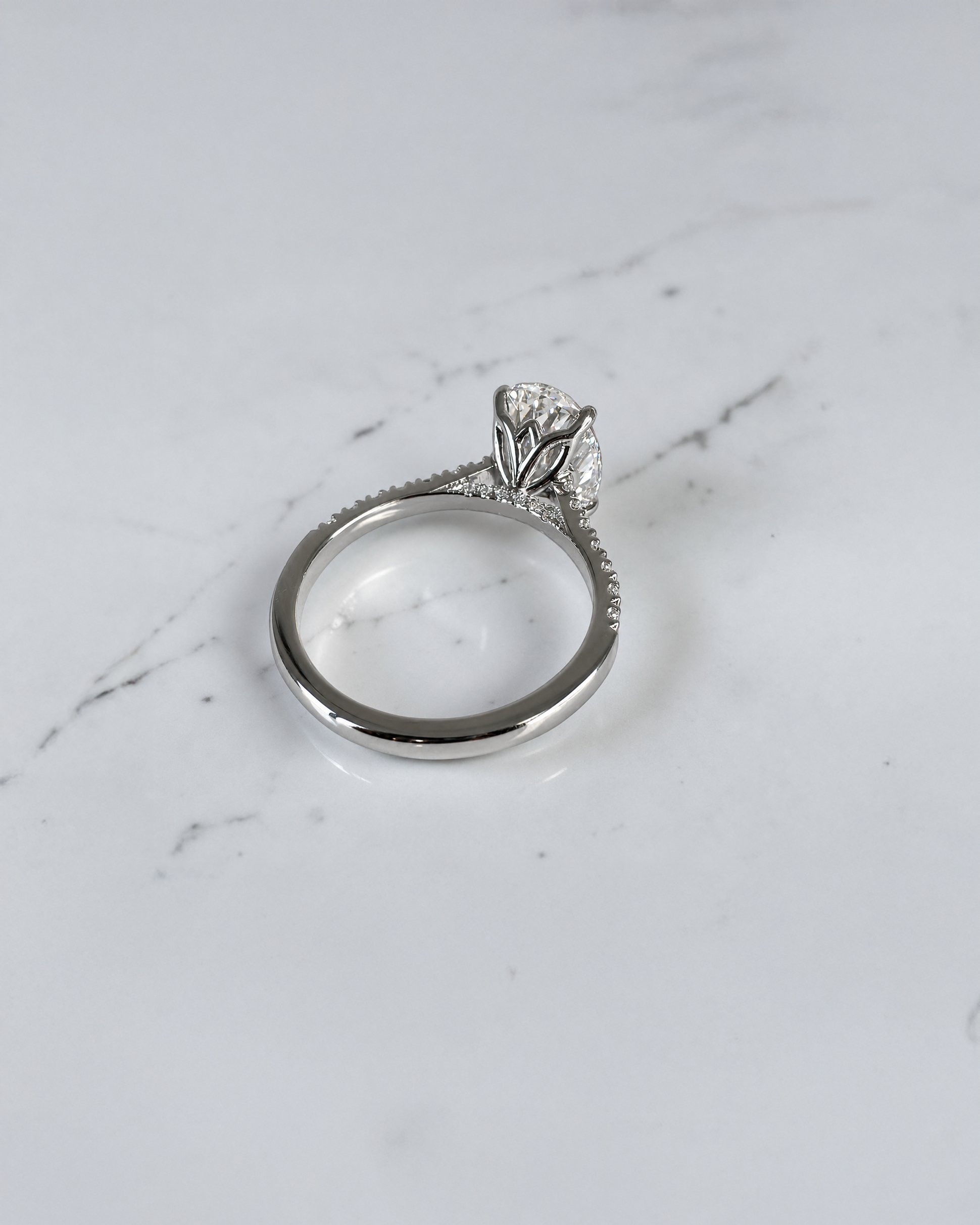 3ct oval cut lab grown diamond engagement platinum ring with lotus head setting, cathedral pavé diamond band and hidden diamond bridge, luxury solitaire ring handcrafted in London