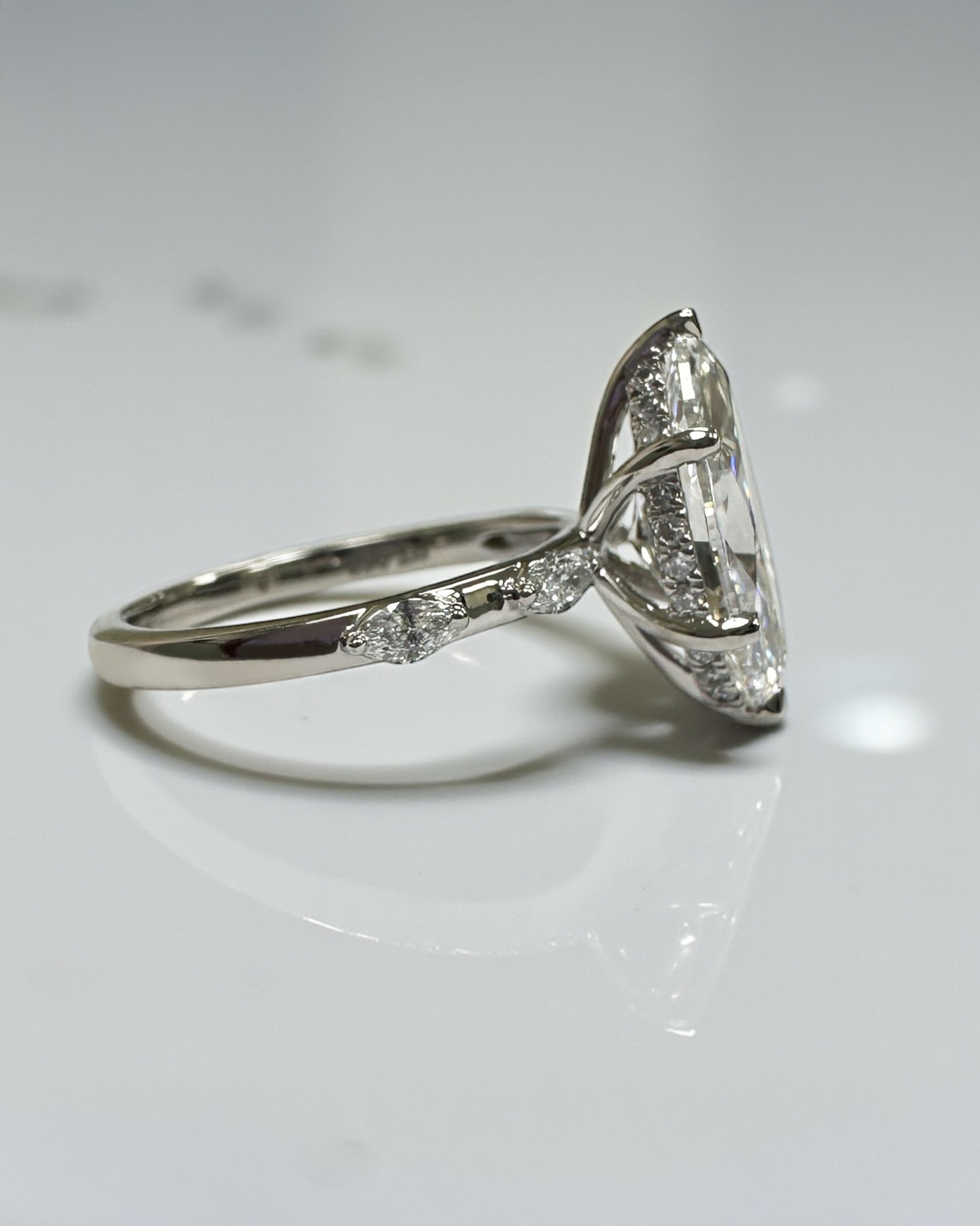 3ct marquise cut lab grown diamond set on a spaced marquise cut band engagement ring platinum 18kt gold