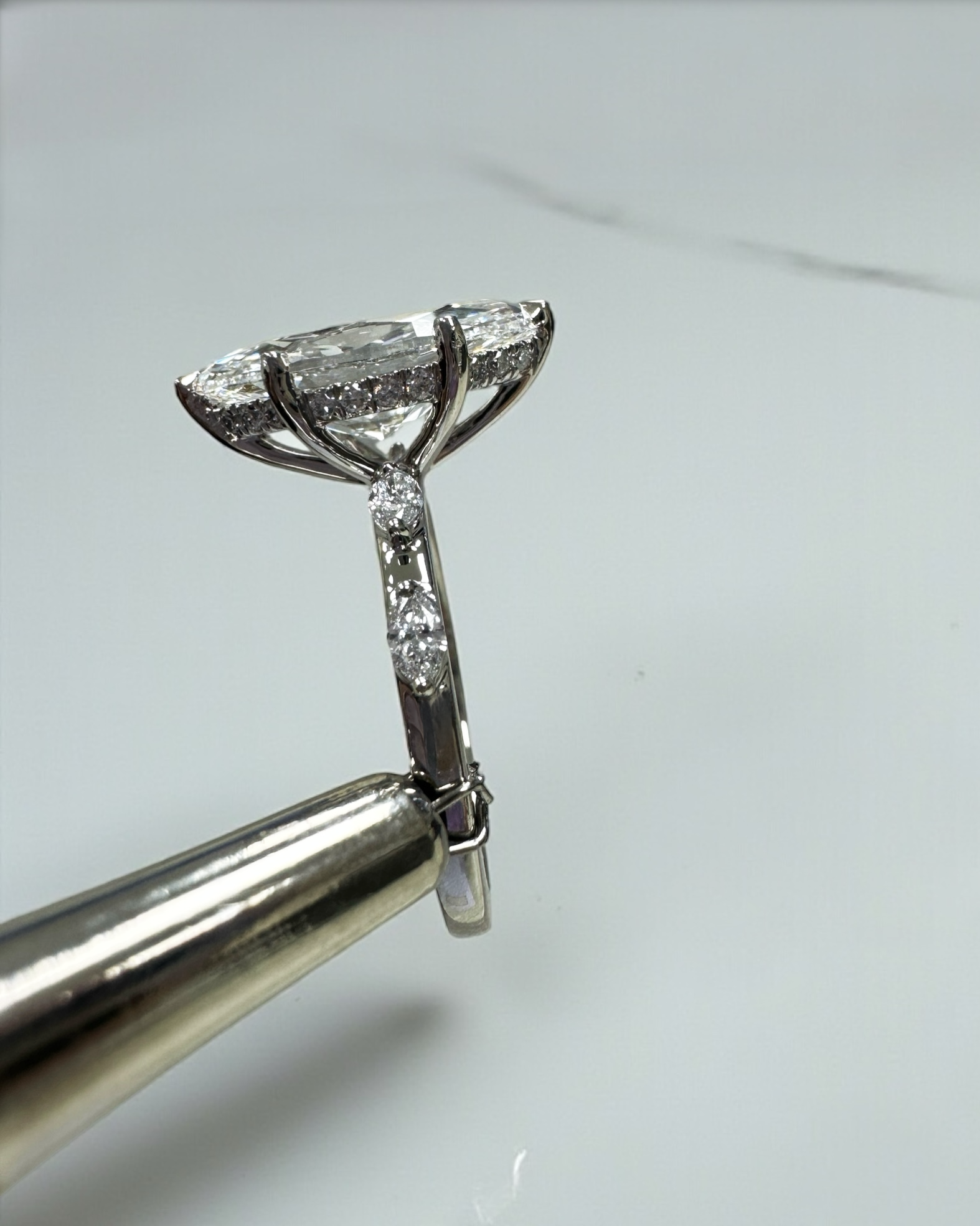 3ct marquise cut lab grown diamond set on a spaced marquise cut band engagement ring platinum 18kt gold