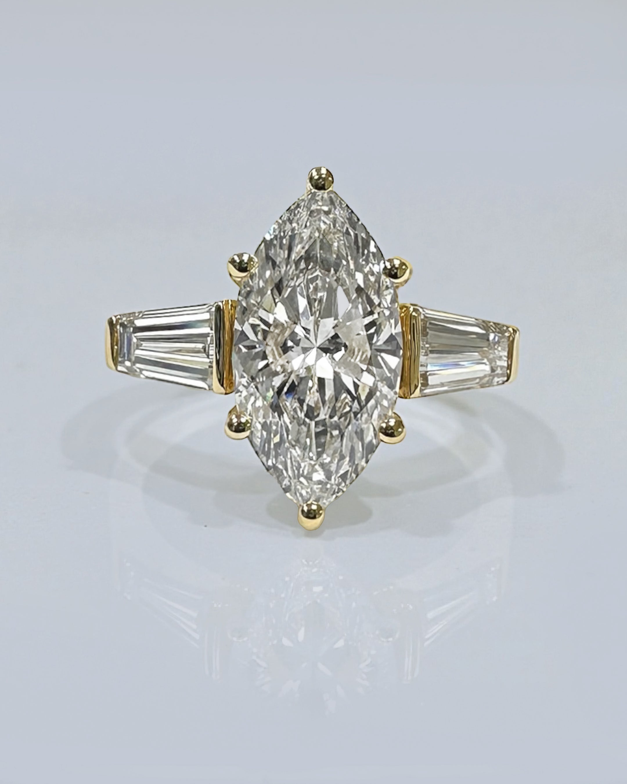3ct marquise cut lab grown diamond trilogy engagement ring with tapered baguette side diamonds in 18kt yellow gold, total 4ct