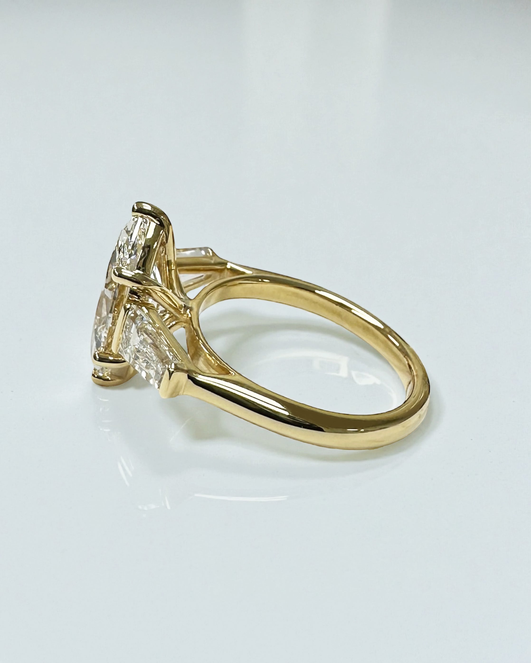 3ct marquise cut lab grown diamond trilogy engagement ring with tapered baguette side diamonds in 18kt yellow gold, total 4ct