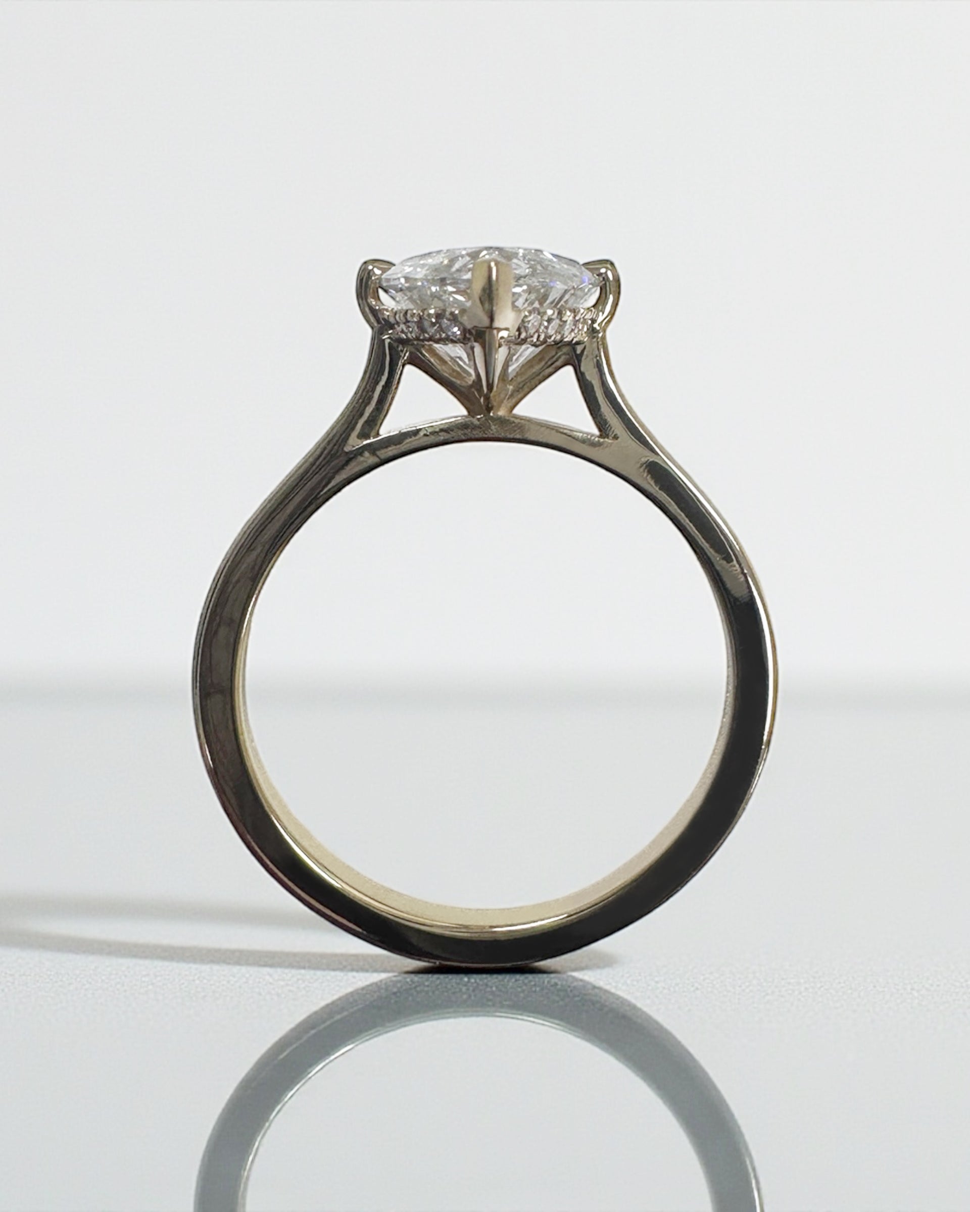 3ct Marquise Cut lab grown Diamond set in a Tapered plain Band Solitaire with a diamond Hidden Halo engagement ring