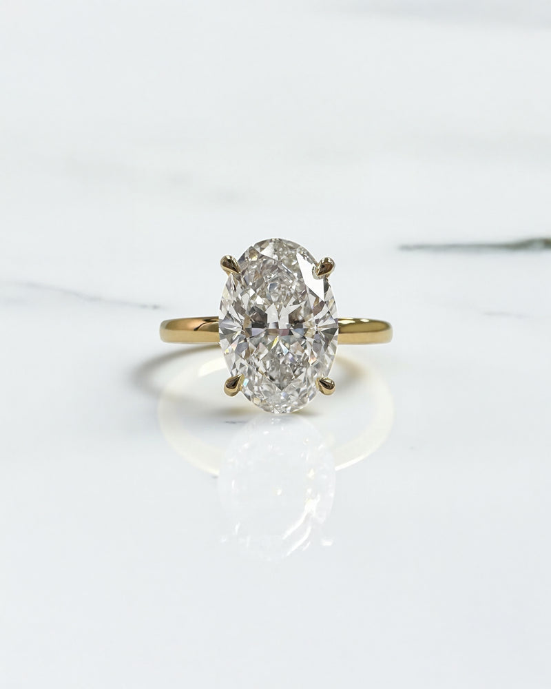 3ct oval lab grown diamond hidden halo solitaire engagement ring in 18kt yellow gold, layla diamonds london