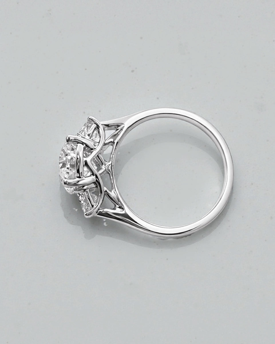 Side view of 3ct oval lab grown diamond ring with half moon side stones and sculpted gallery in white gold
