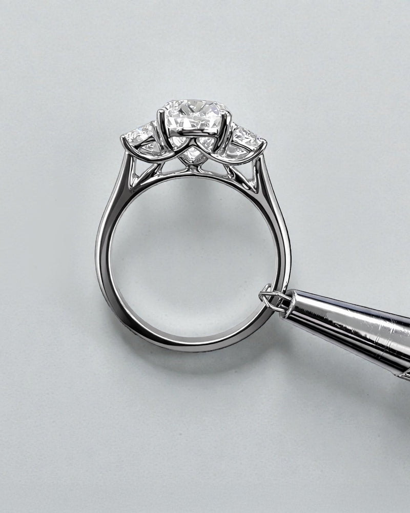 Side view of 3ct oval lab grown diamond ring with half moon side stones and sculpted gallery in white gold
