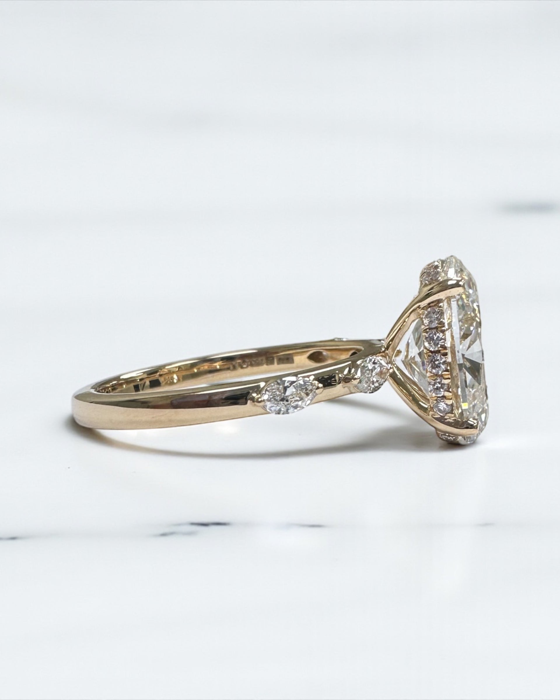 3ct oval cut lab grown diamond marquise spaced band engagement ring, hidden halo 18kt yellow gold made in London by Layla Diamonds