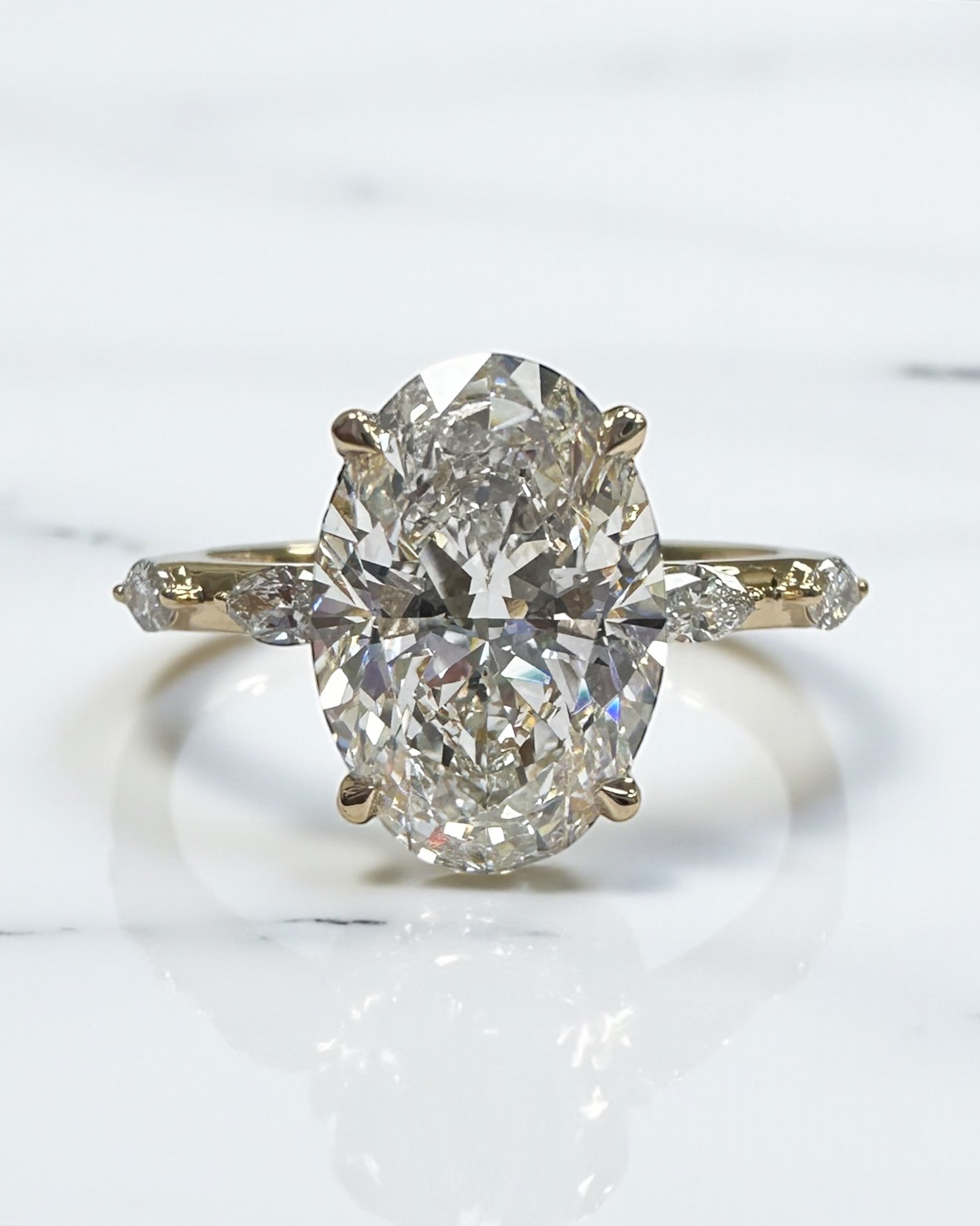 3ct oval cut lab grown diamond marquise spaced band engagement ring, hidden halo 18kt yellow gold made in London by Layla Diamonds