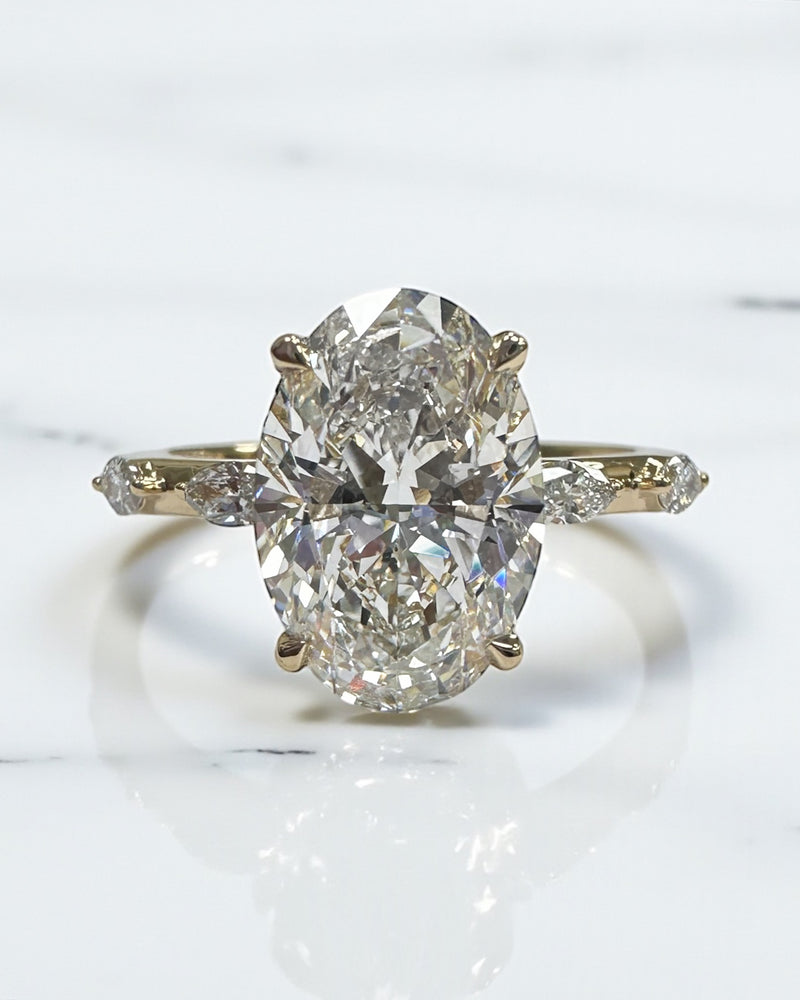 3ct oval cut lab grown diamond marquise spaced band engagement ring, hidden halo 18kt yellow gold made in London by Layla Diamonds