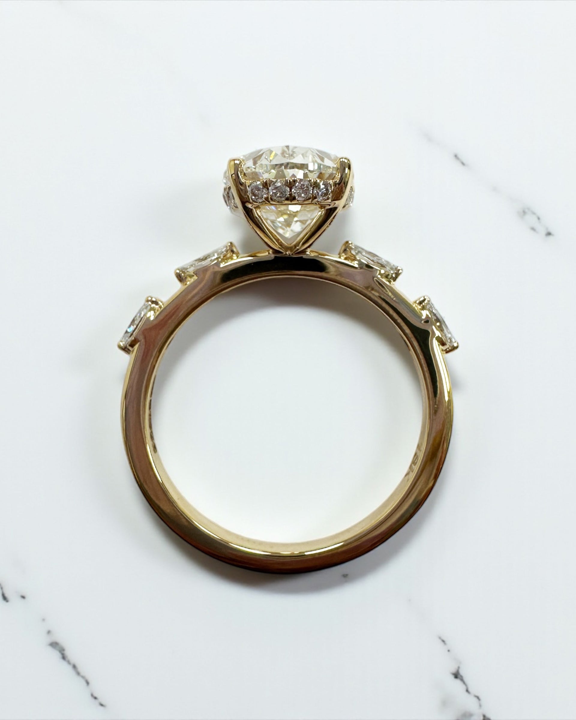 3ct oval cut lab grown diamond marquise spaced band engagement ring, hidden halo 18kt yellow gold made in London by Layla Diamonds