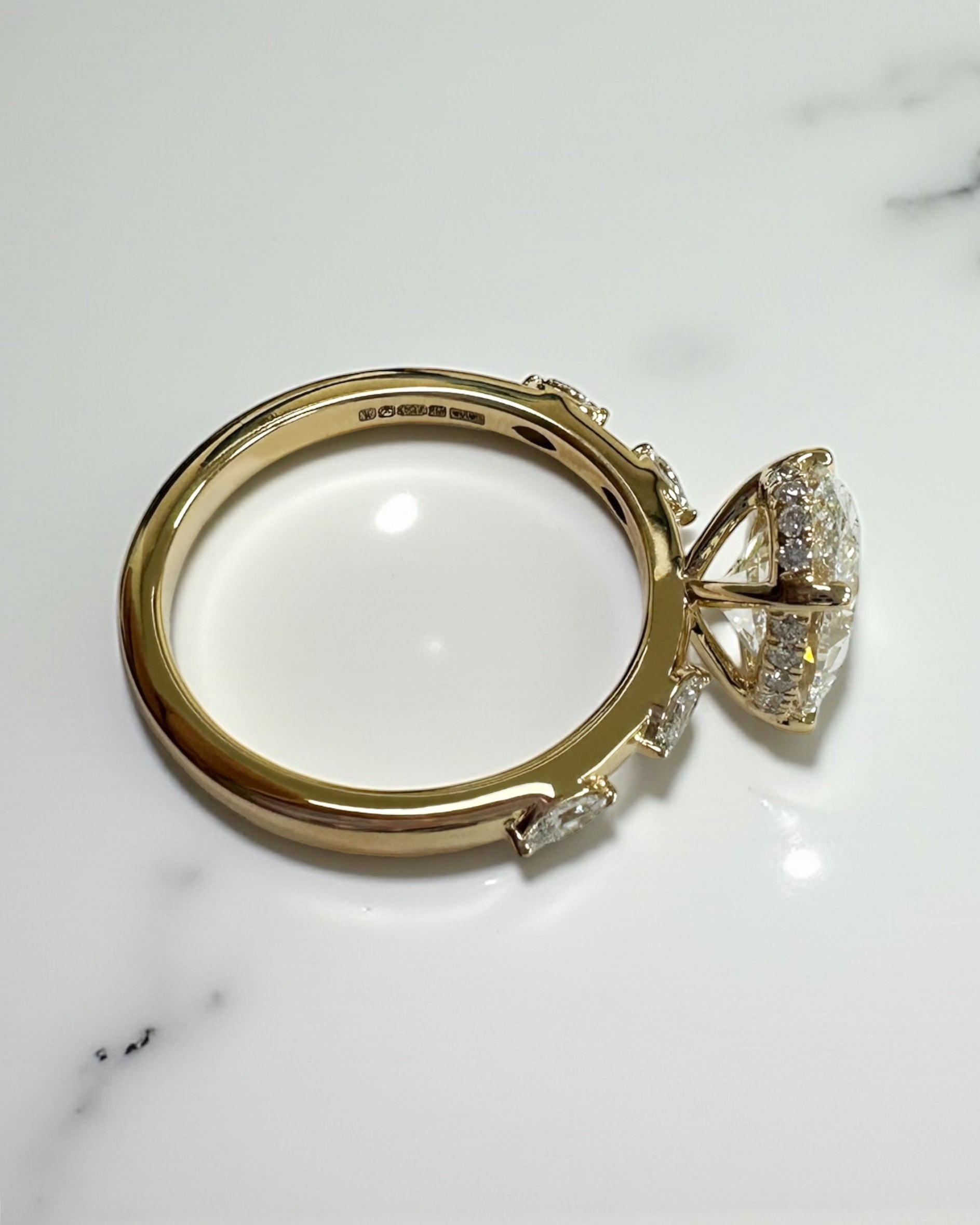 3ct oval cut lab grown diamond marquise spaced band engagement ring, hidden halo 18kt yellow gold made in London by Layla Diamonds