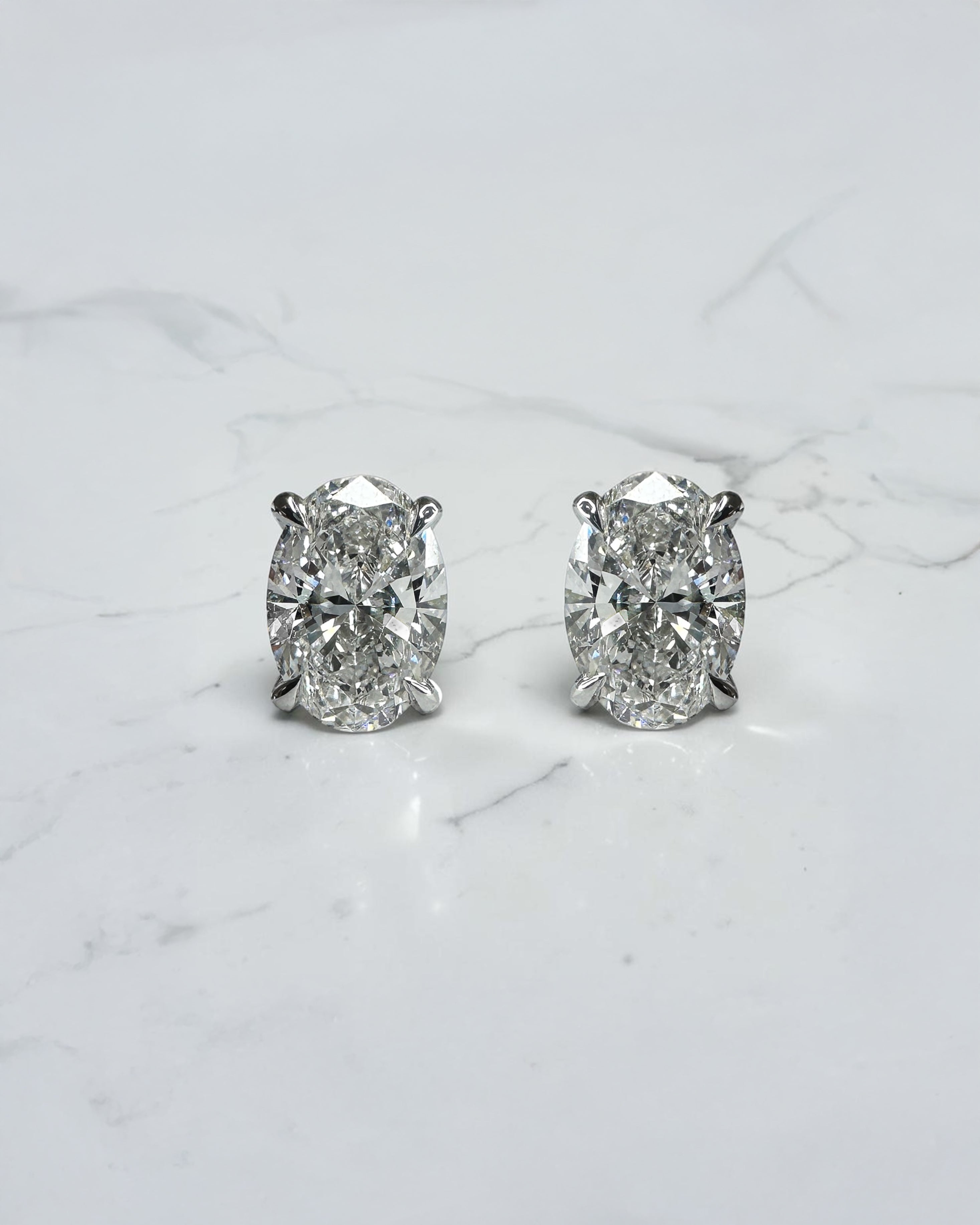 3ct lab grown oval diamond stud earrings featuring two 1.50ct oval brilliant cut diamonds in a classic four prong setting.
