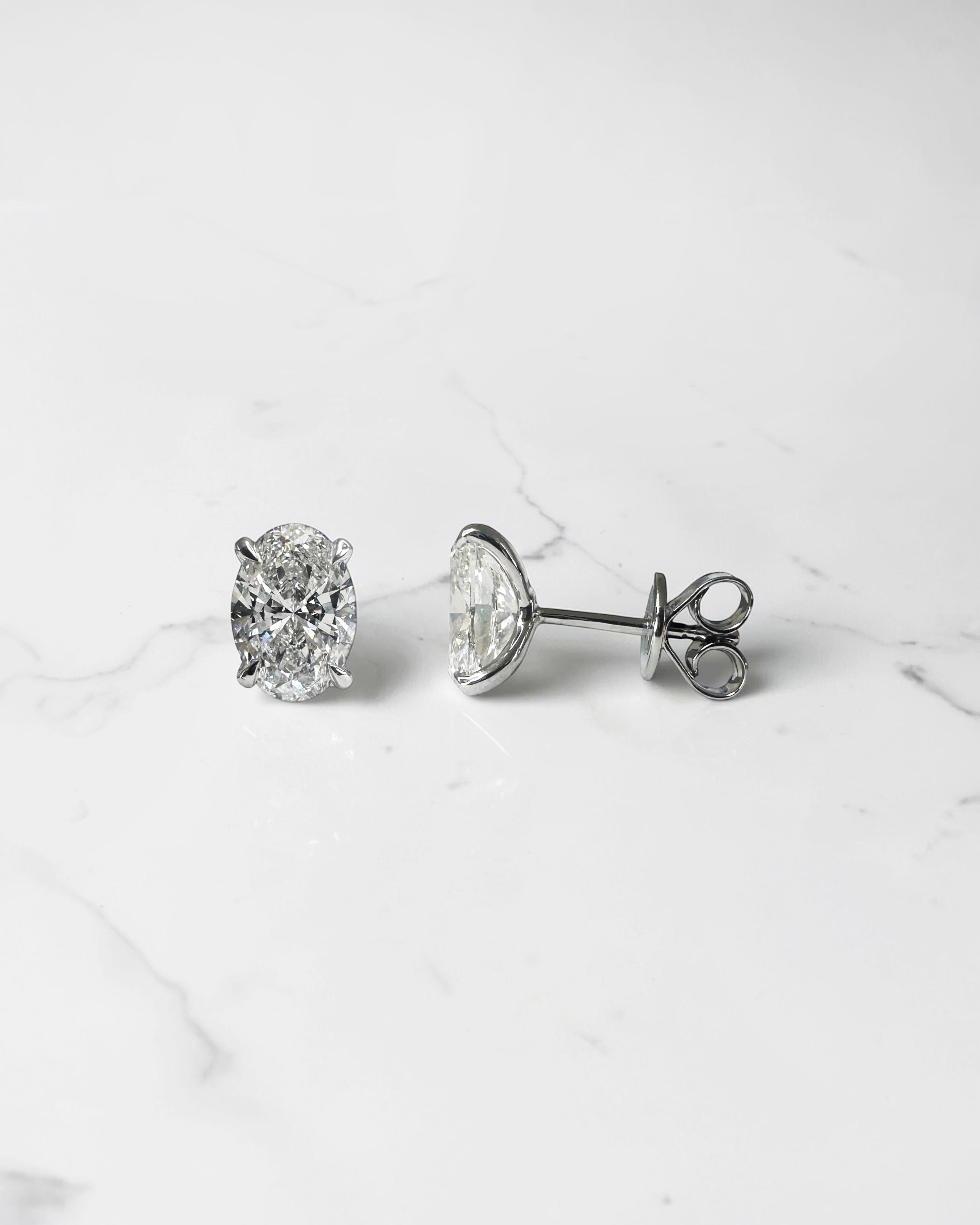 3ct lab grown oval diamond stud earrings featuring two 1.50ct oval brilliant cut diamonds in a classic four prong setting.