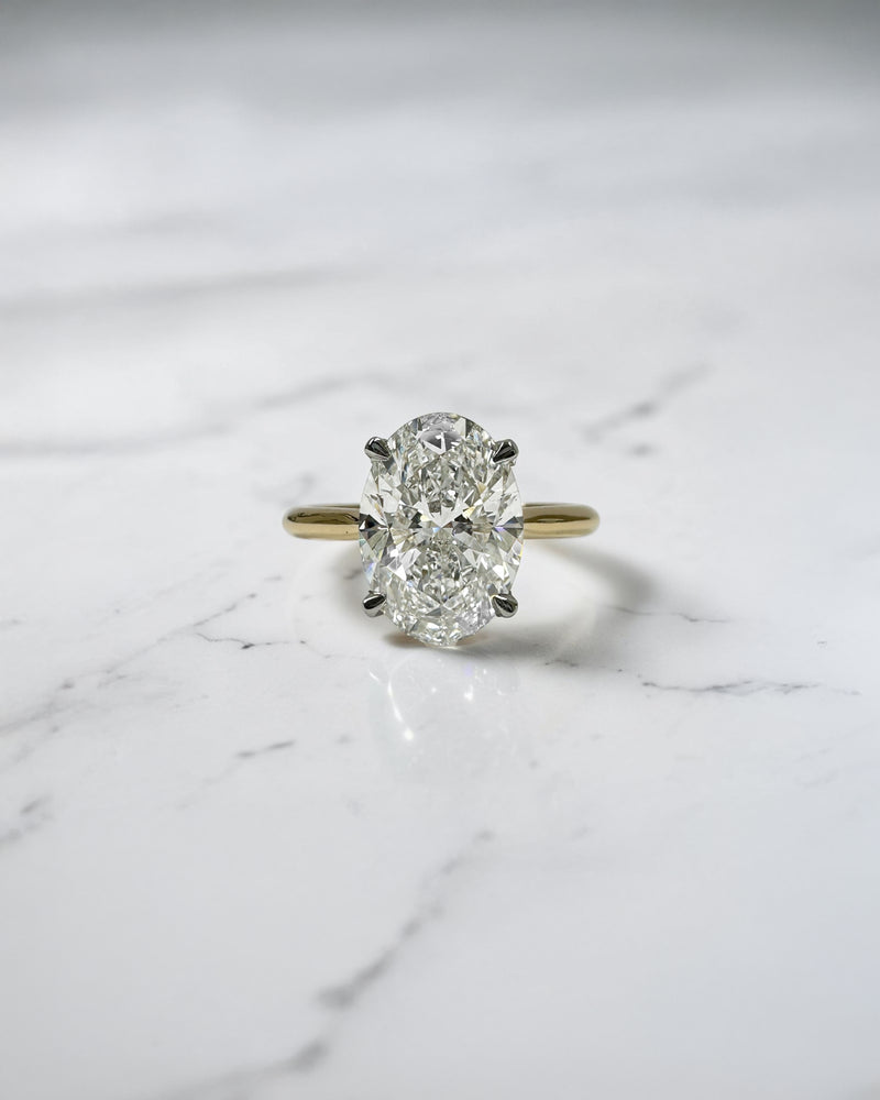 3ct oval cut lab grown diamond engagement ring with hidden halo and cathedral setting in two tone yellow gold plain band with platinum head solitaire, handcrafted in London