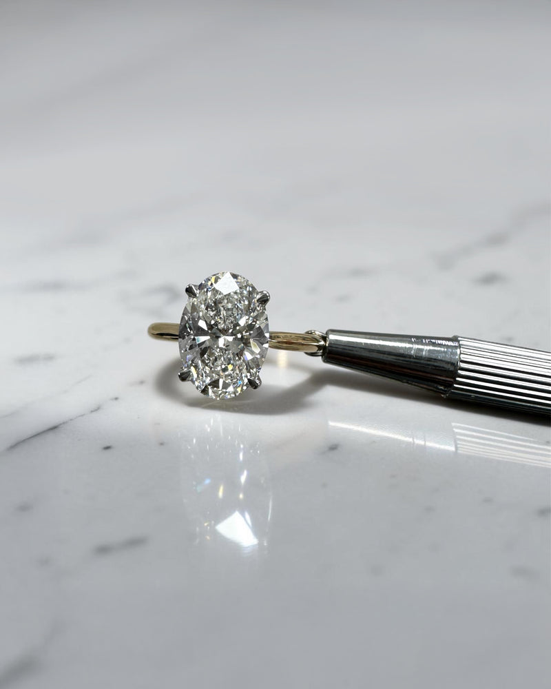 3ct oval cut lab grown diamond engagement ring with hidden halo and cathedral setting in two tone yellow gold plain band with platinum head solitaire, handcrafted in London