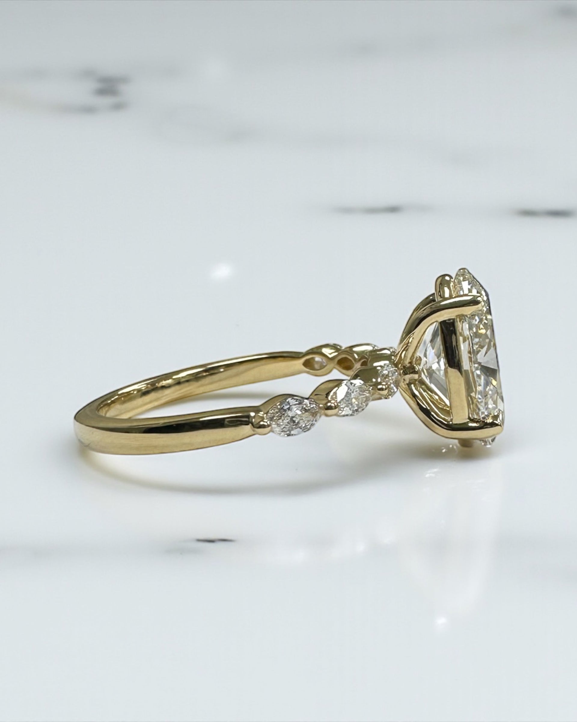 3ct Oval cut lab grown diamond engagement ring with marquise diamond band, crafted in 18kt yellow gold by Layla Diamonds London.