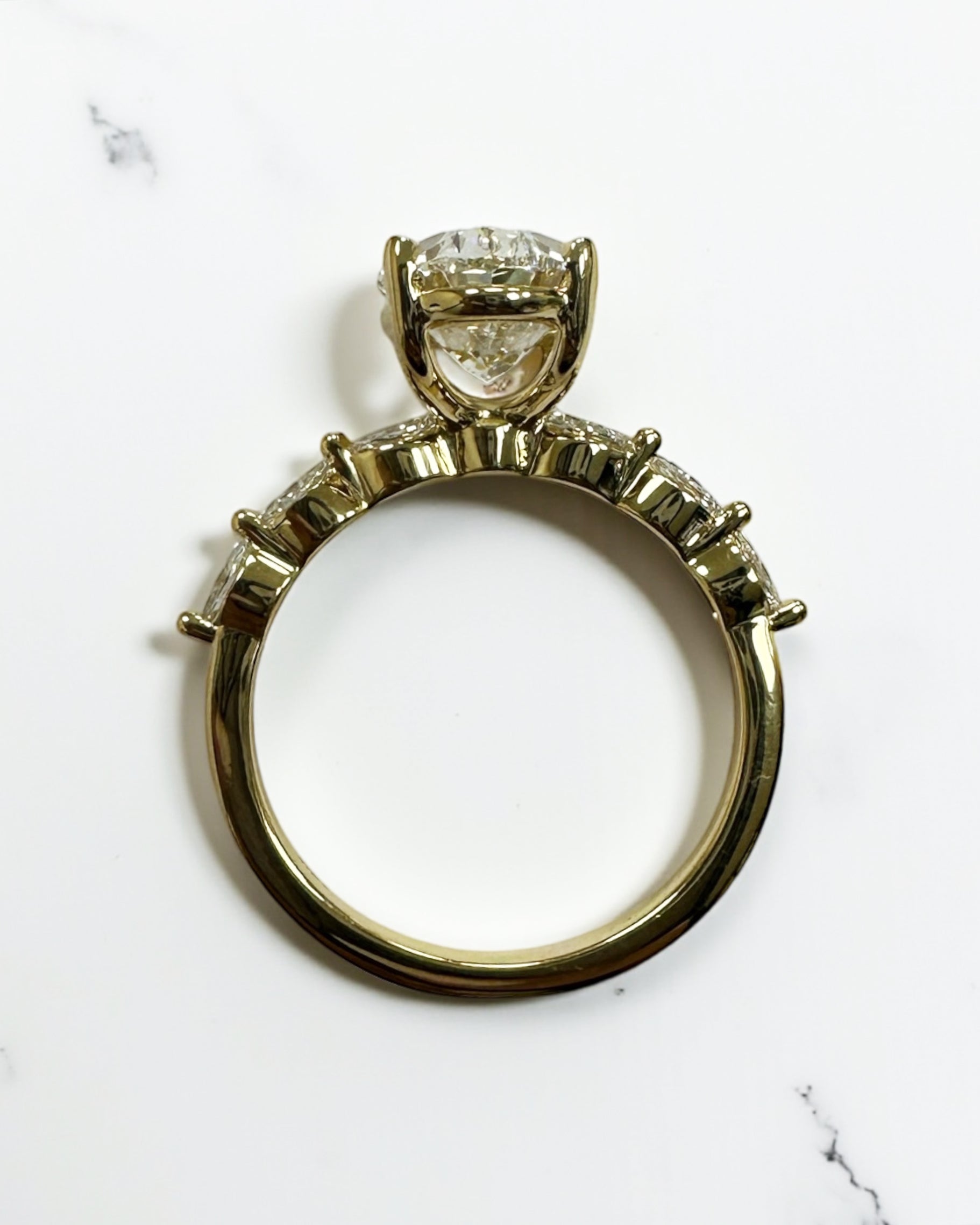 3ct Oval cut lab grown diamond engagement ring with marquise diamond band, crafted in 18kt yellow gold by Layla Diamonds London.