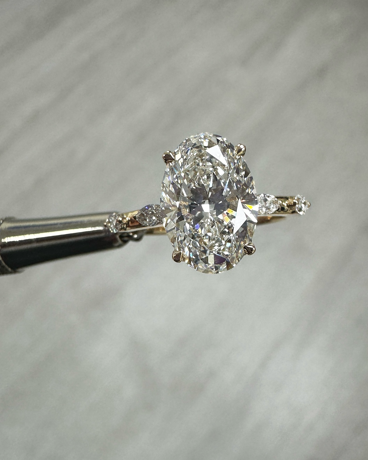 3ct oval cut lab grown diamond marquise spaced band engagement ring, hidden halo 18kt yellow gold made in London by Layla Diamonds