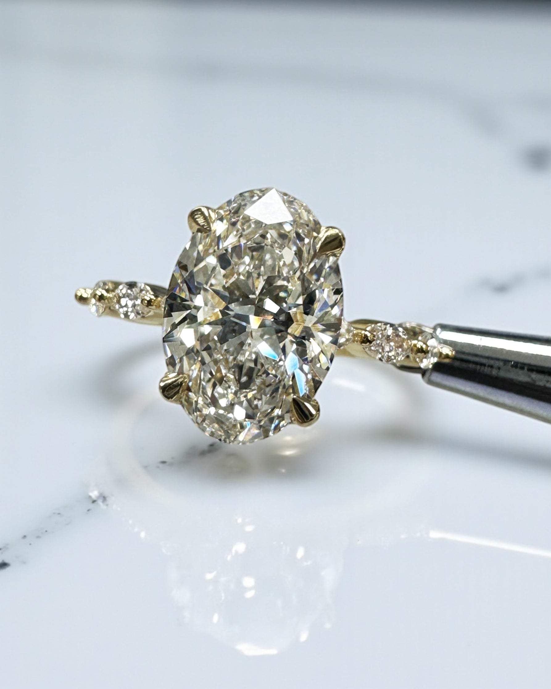 3ct Oval cut lab grown diamond engagement ring with marquise diamond band, crafted in 18kt yellow gold by Layla Diamonds London.