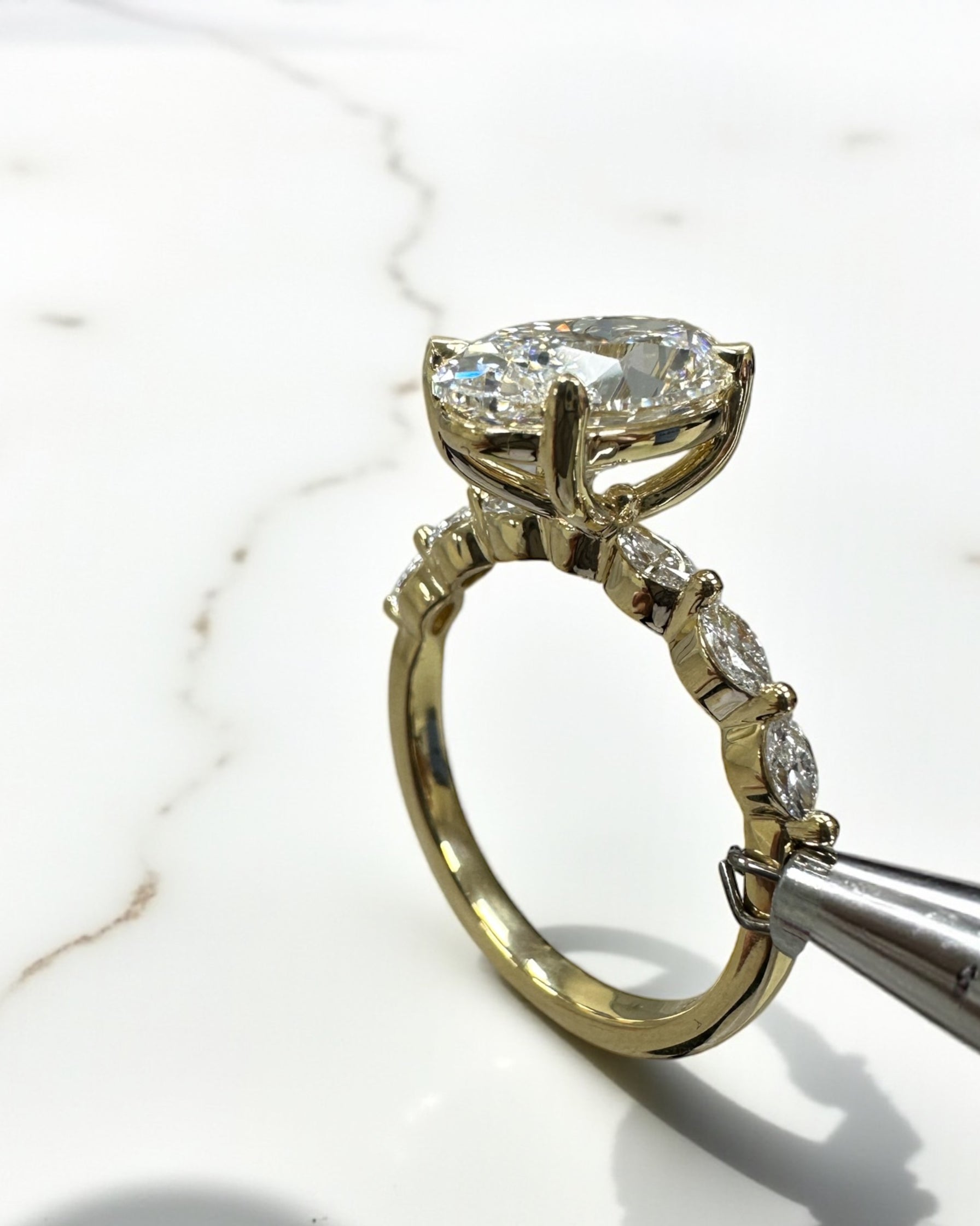 3ct Oval cut lab grown diamond engagement ring with marquise diamond band, crafted in 18kt yellow gold by Layla Diamonds London.
