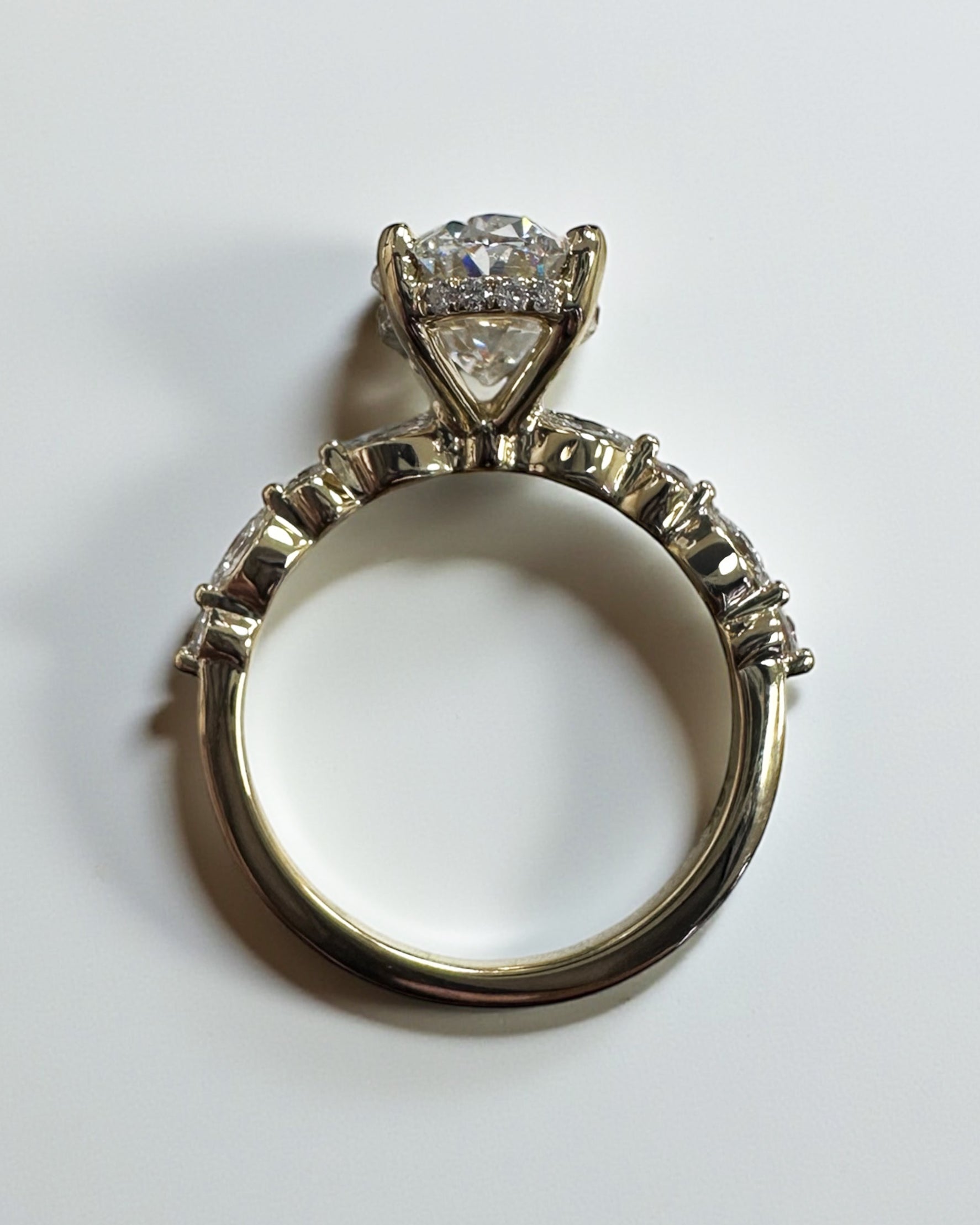 Oval 3ct lab grown diamond ring featuring marquise and round diamond band and delicate hidden halo 18kt yellow gold