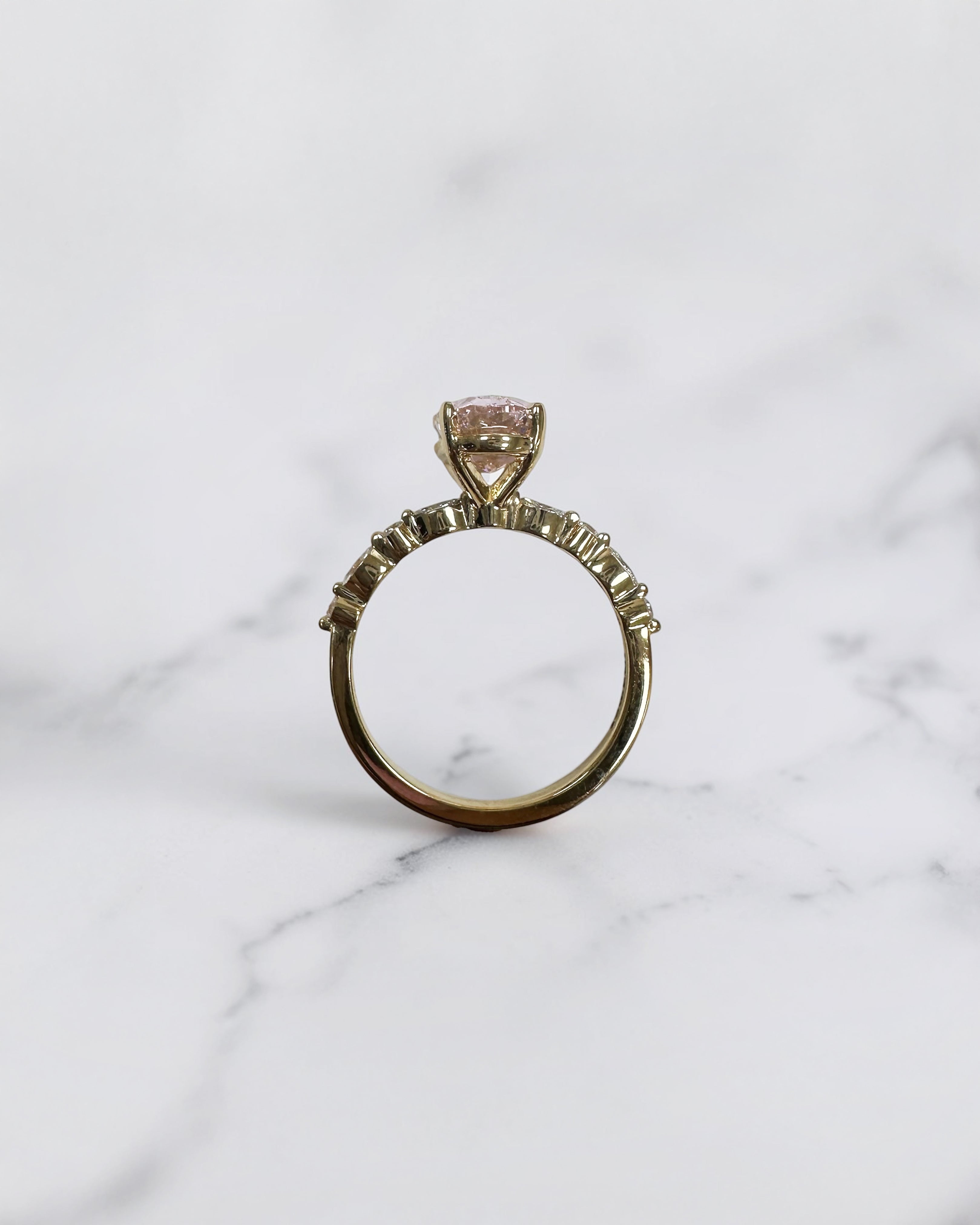 3ct pink oval cut lab grown diamond engagement ring with a floating setting, marquise and round diamond band in 18ct yellow gold, handcrafted in London by Layla Diamonds.