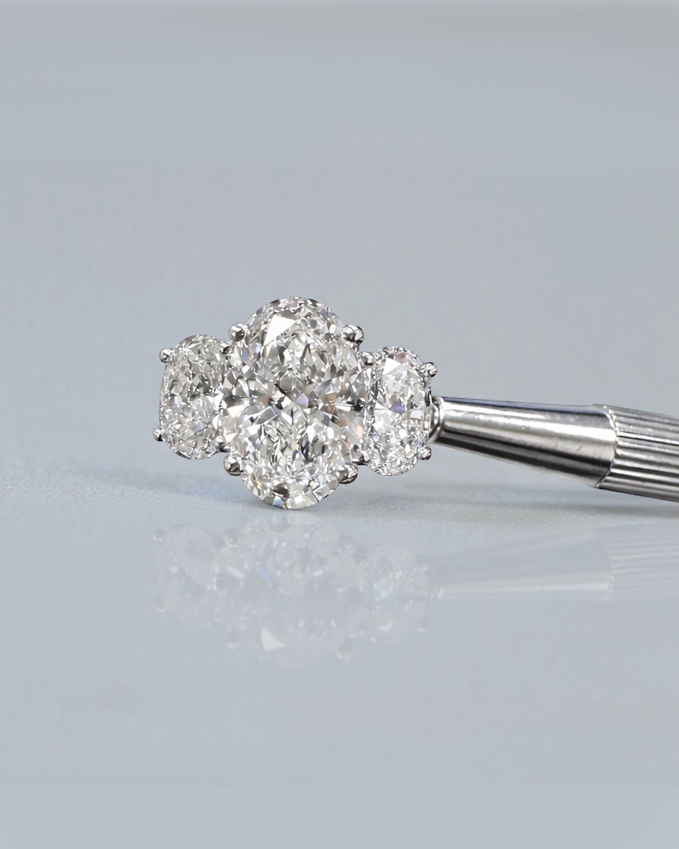 5ct oval cut lab grown diamond trilogy engagement ring with 3ct centre oval and matching oval side stones in polished white gold or platinum setting
