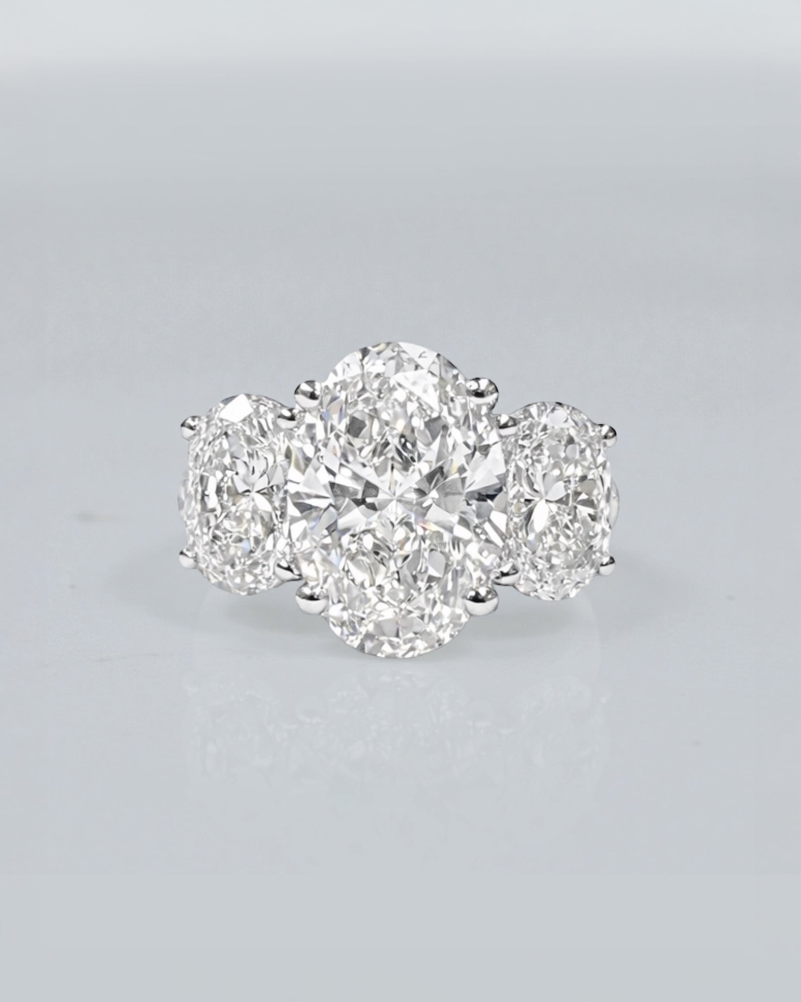 5ct oval cut lab grown diamond trilogy engagement ring with 3ct centre oval and matching oval side stones in polished white gold or platinum setting