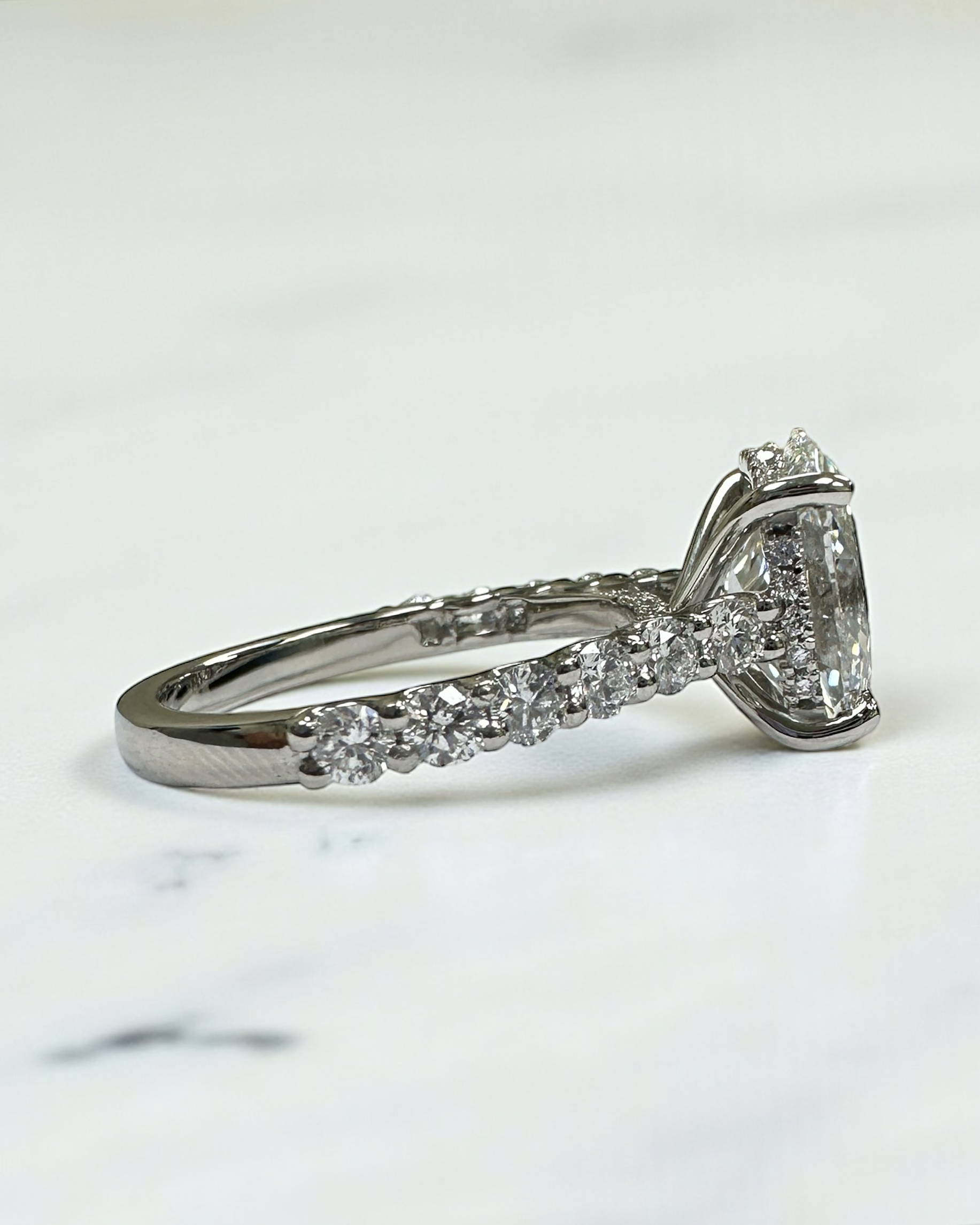 3ct oval cut lab grown diamond u prong setting, cathedral engagement ring in platinum on hand