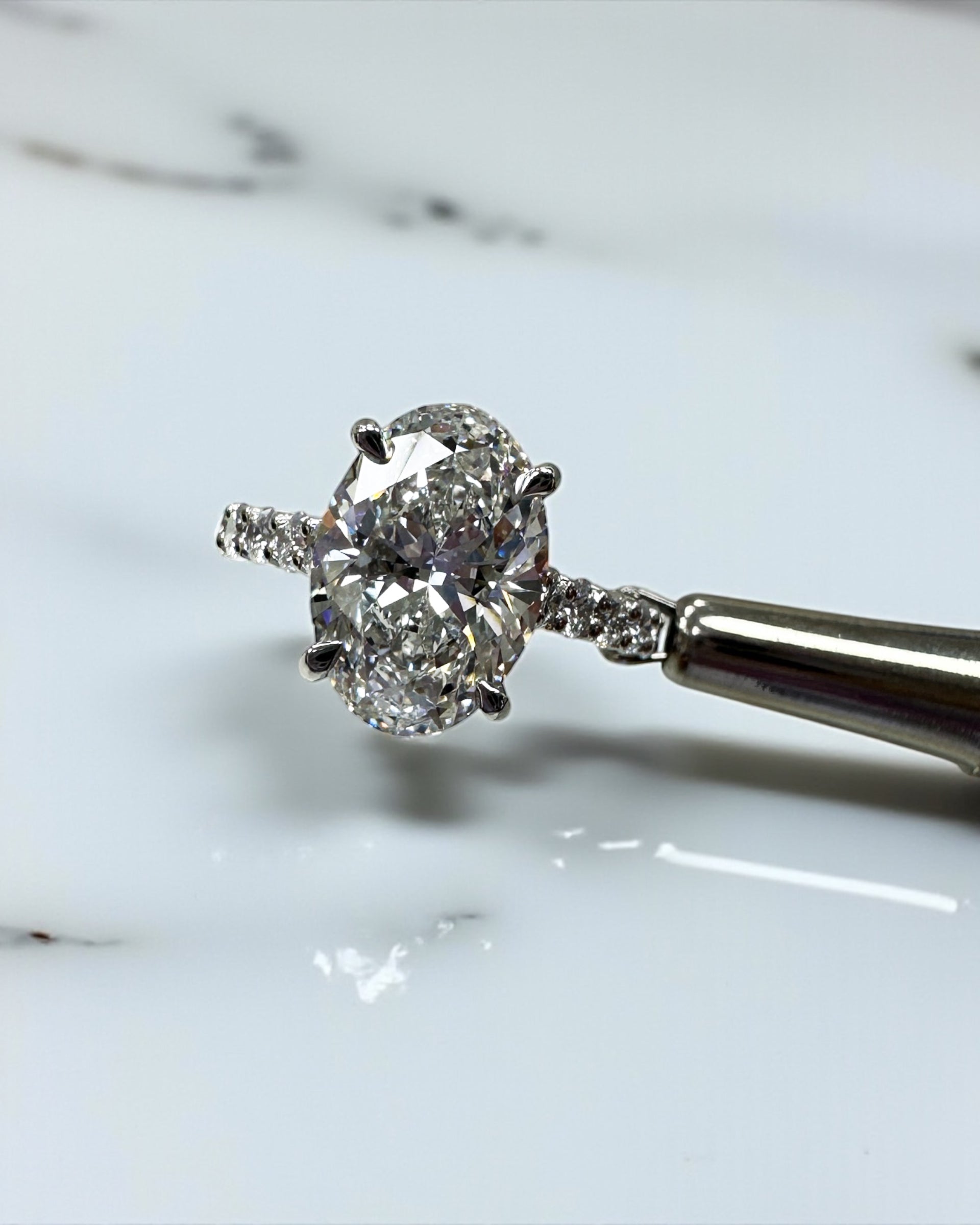3ct oval cut lab grown diamond u prong setting, cathedral engagement ring in platinum on hand