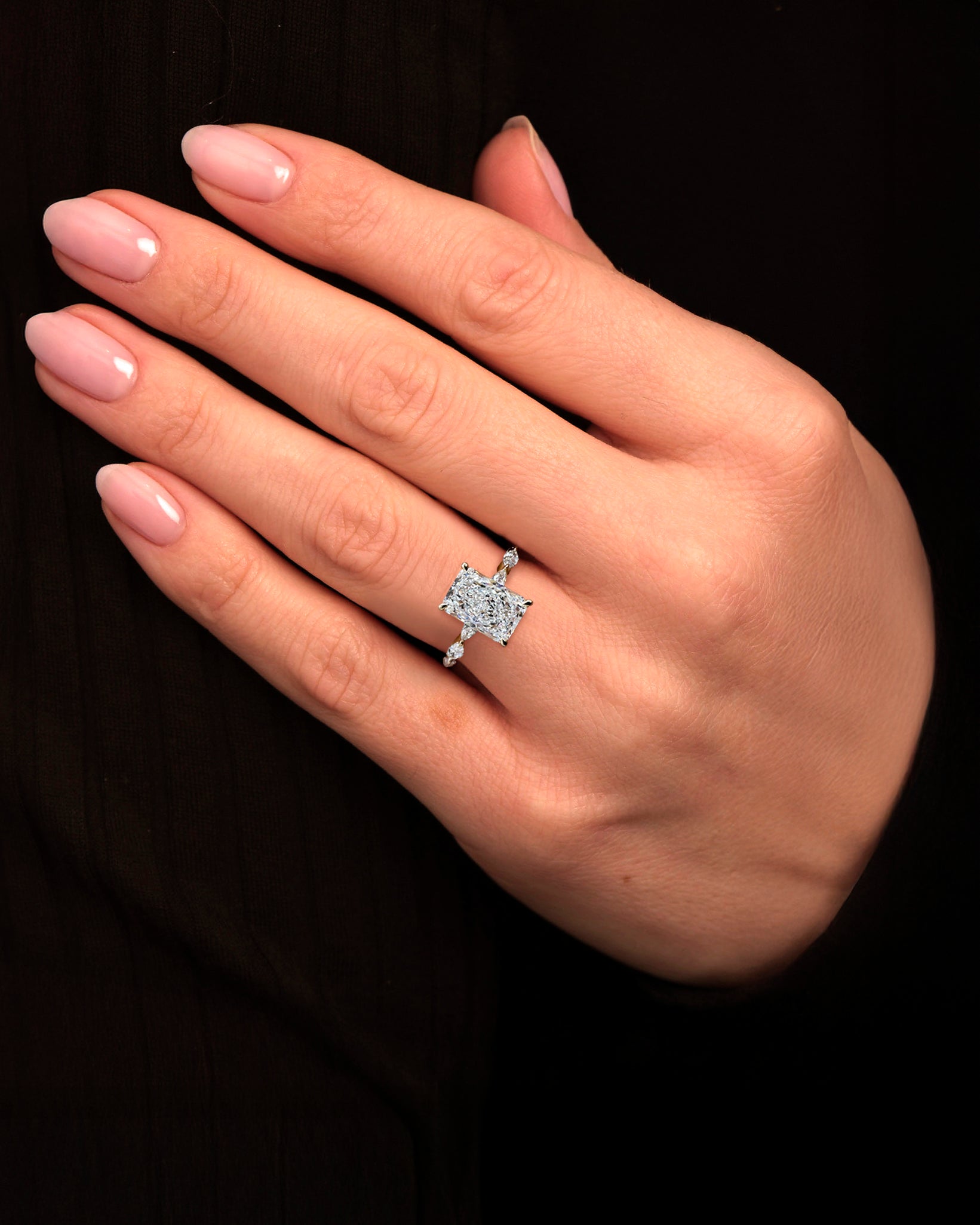 3ct Radiant cut lab grown diamond set with marquise side diamonds on the band, engagement ring, 18kt yellow gold on hand