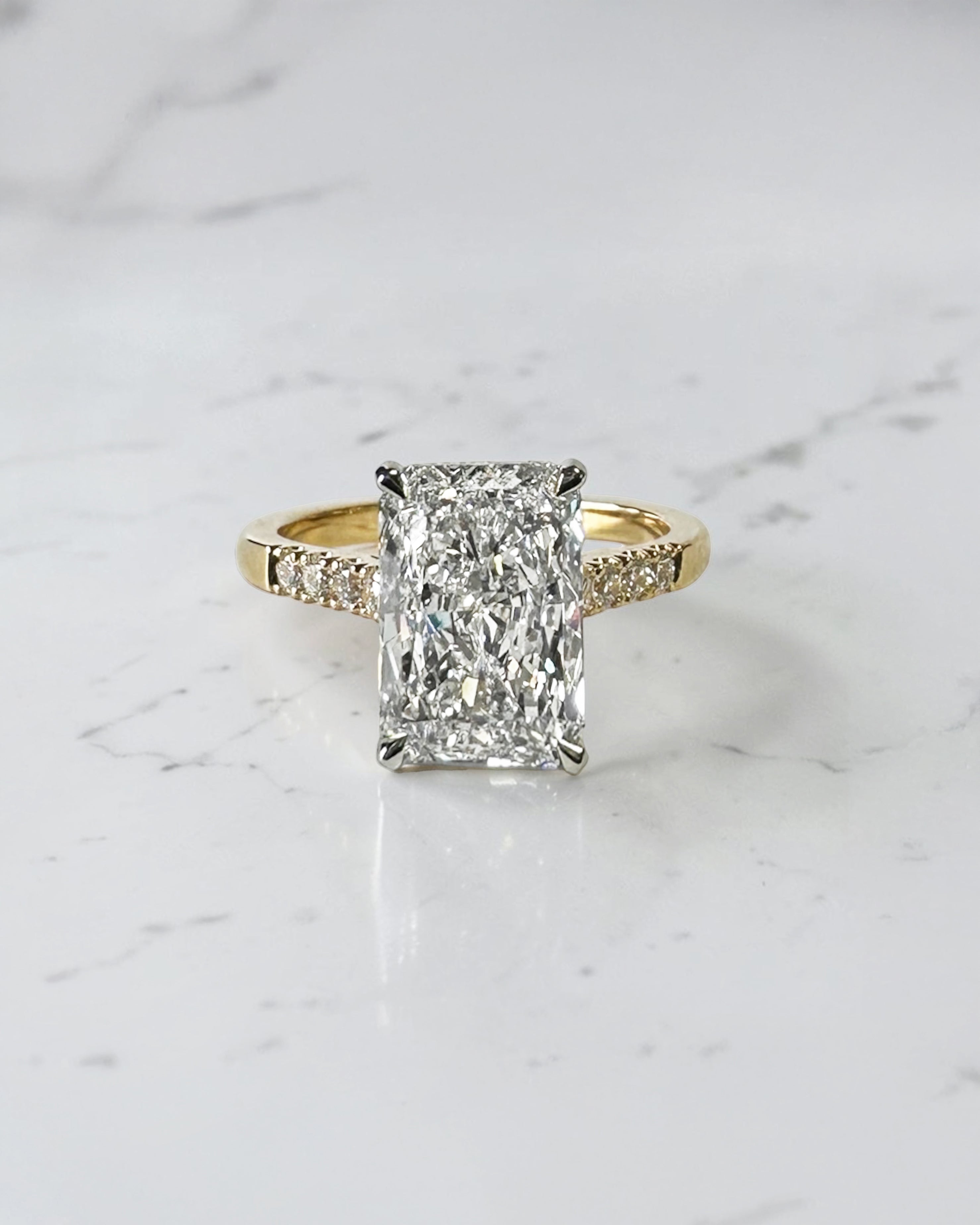 3ct radiant cut lab grown diamond engagement ring with partial pavé band, cathedral setting, hidden halo and two tone yellow gold band