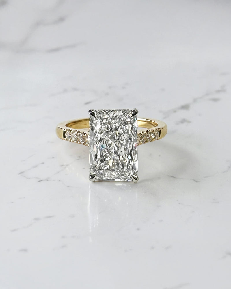 3ct radiant cut lab grown diamond engagement ring with partial pavé band, cathedral setting, hidden halo and two tone yellow gold band